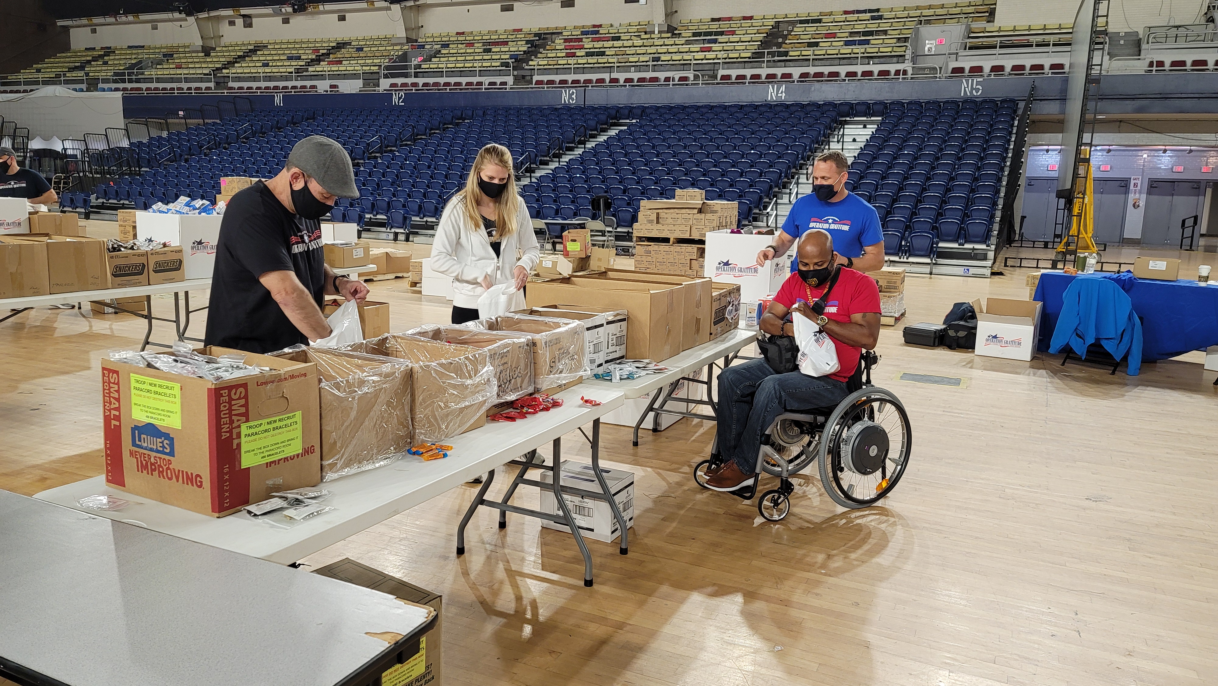 Schmiegel and Gillums assembling Operation Gratitude care packages for veterans on Veterans Day at the DC National Guard Armory. 