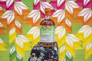 Third Collectors Art Series, a limited release of 96 proof PX Naranja Cask Finish Whiskey