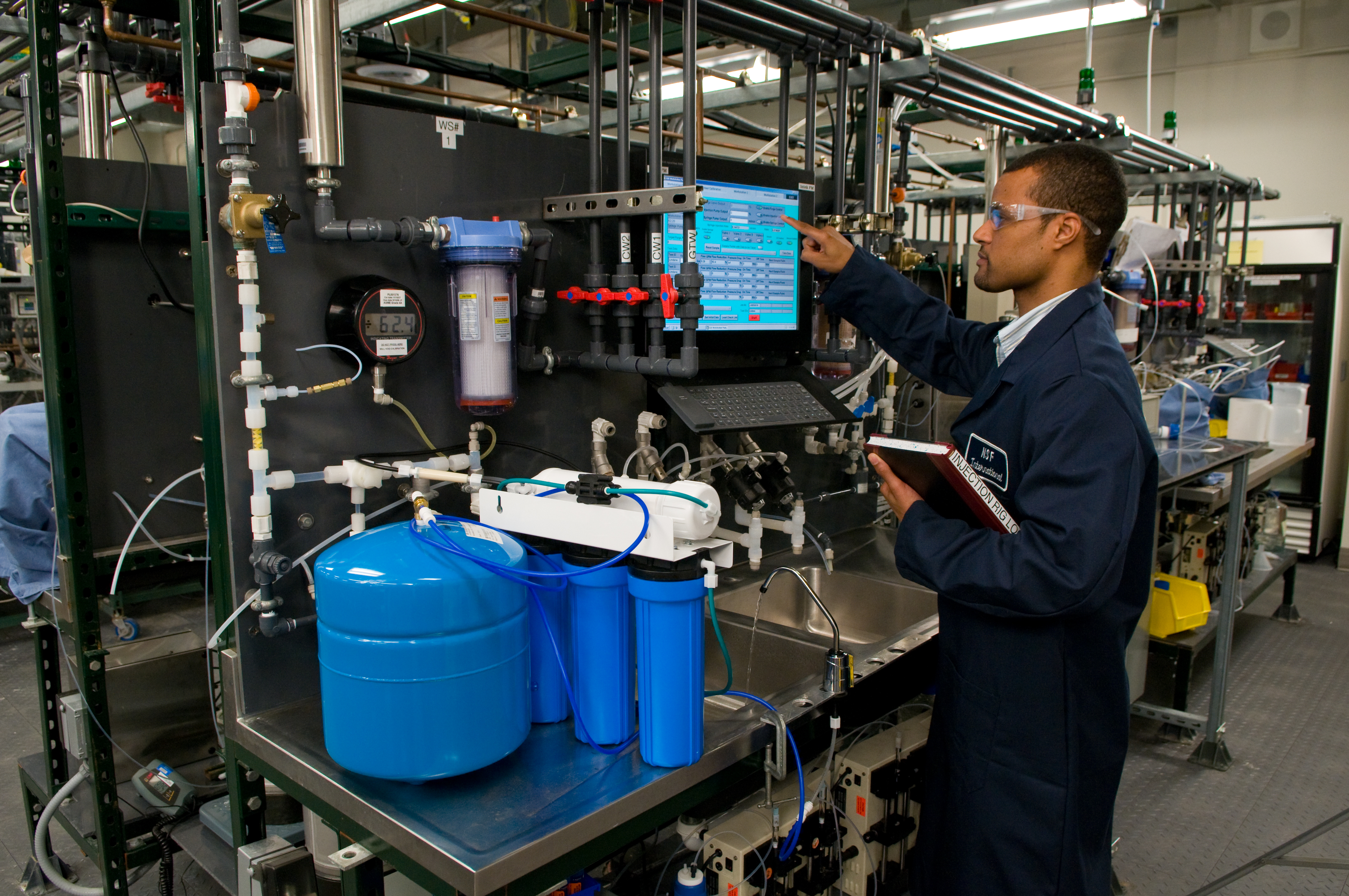 An NSF International lab technician tests a drinking water treatment unit for effectiveness in reduction of contaminants. 

Photo Credit: NSF International