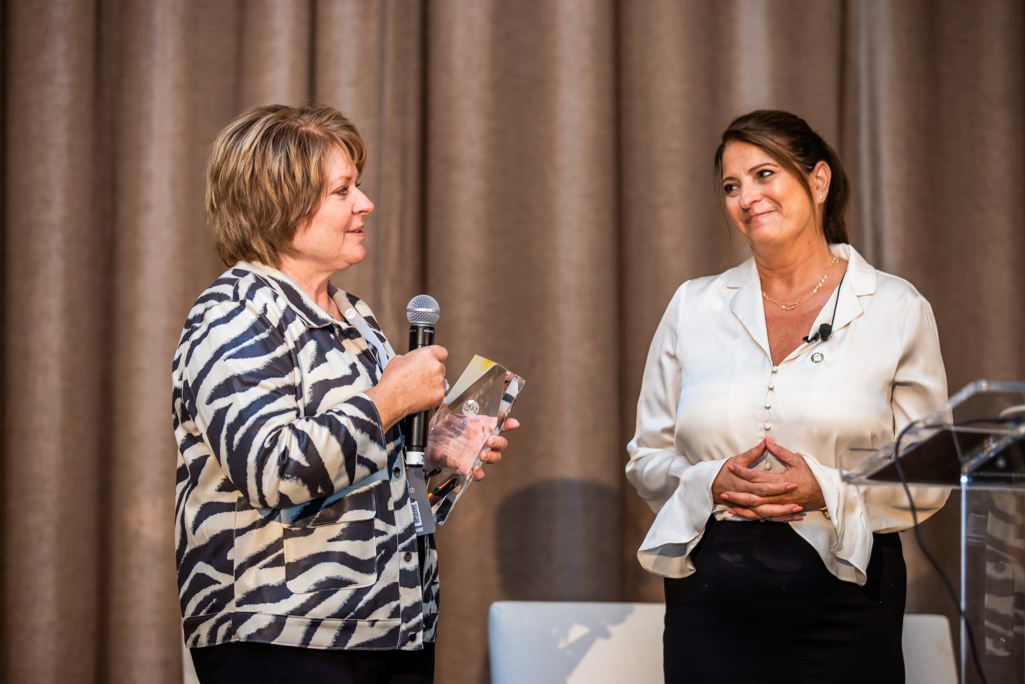 Woman receiving an award from another woman