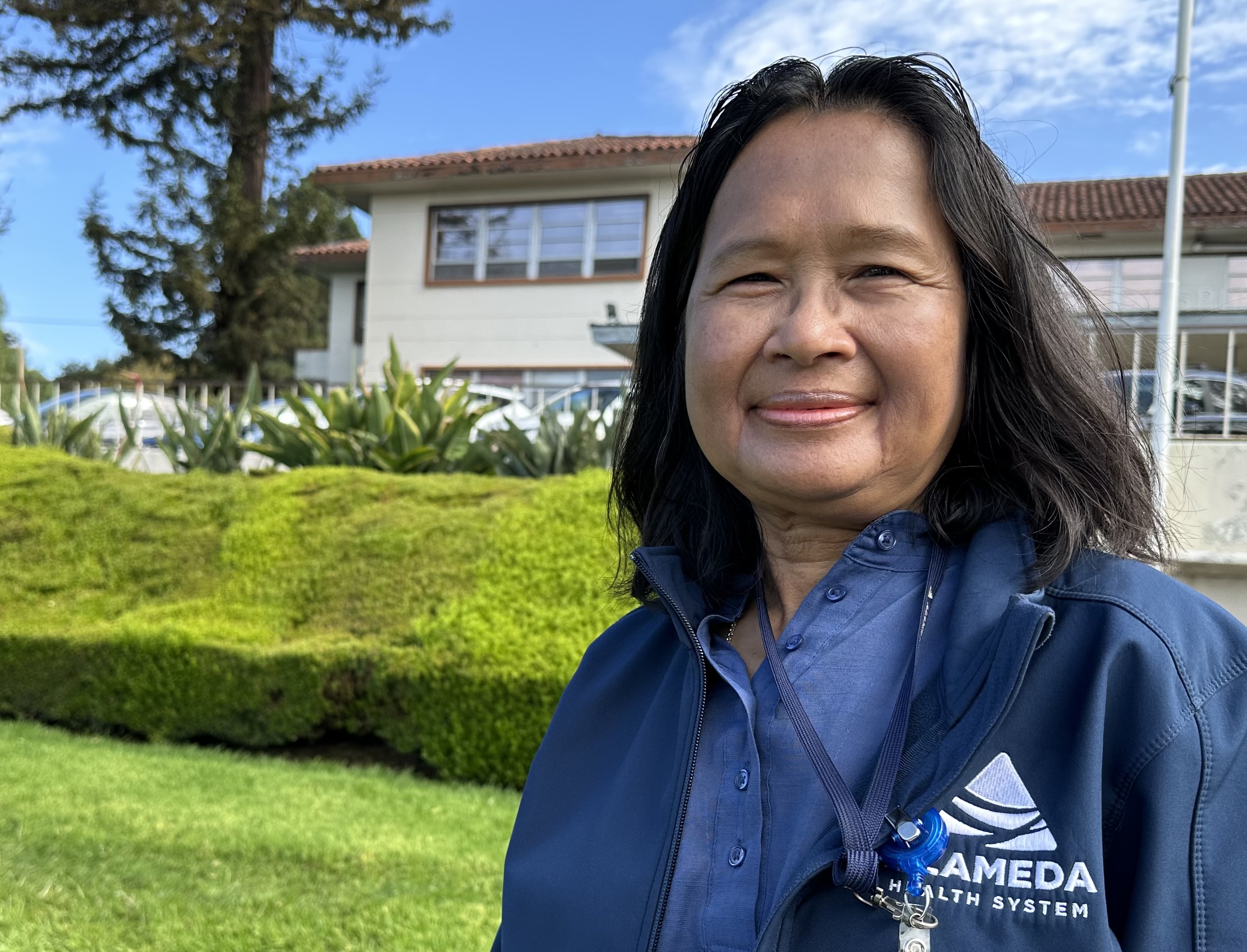 AHS manager of interpreter services Sambo Ly stands for a portrait outside Fairmont Hospital in Alameda County