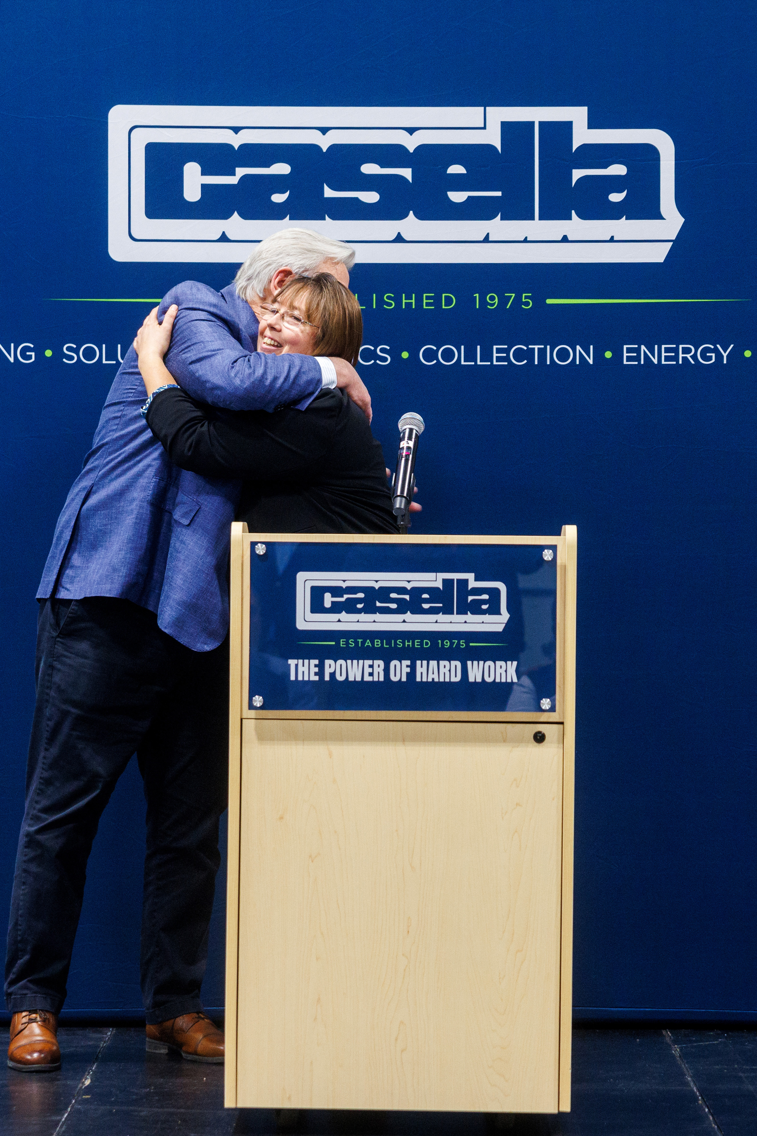 John W. Casella, Chairman & CEO of Casella Waste Systems, Inc. hugs Courtney Hier, daughter of Ken Hier Sr. at the dedication of the Kenneth A. Hier S