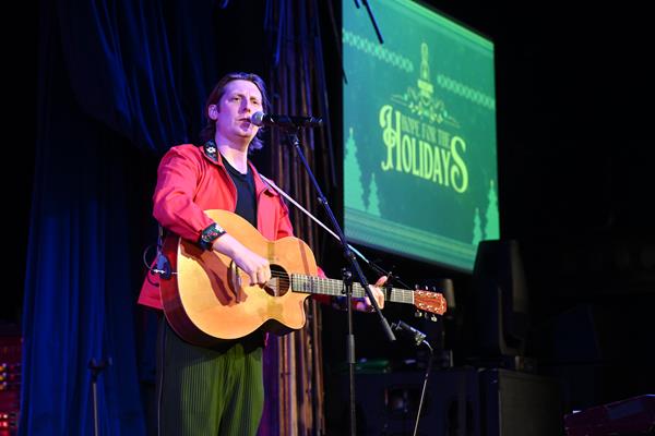 Eric Hutchinson performs at Musicians On Call's Hope for the Holidays concert for caregivers