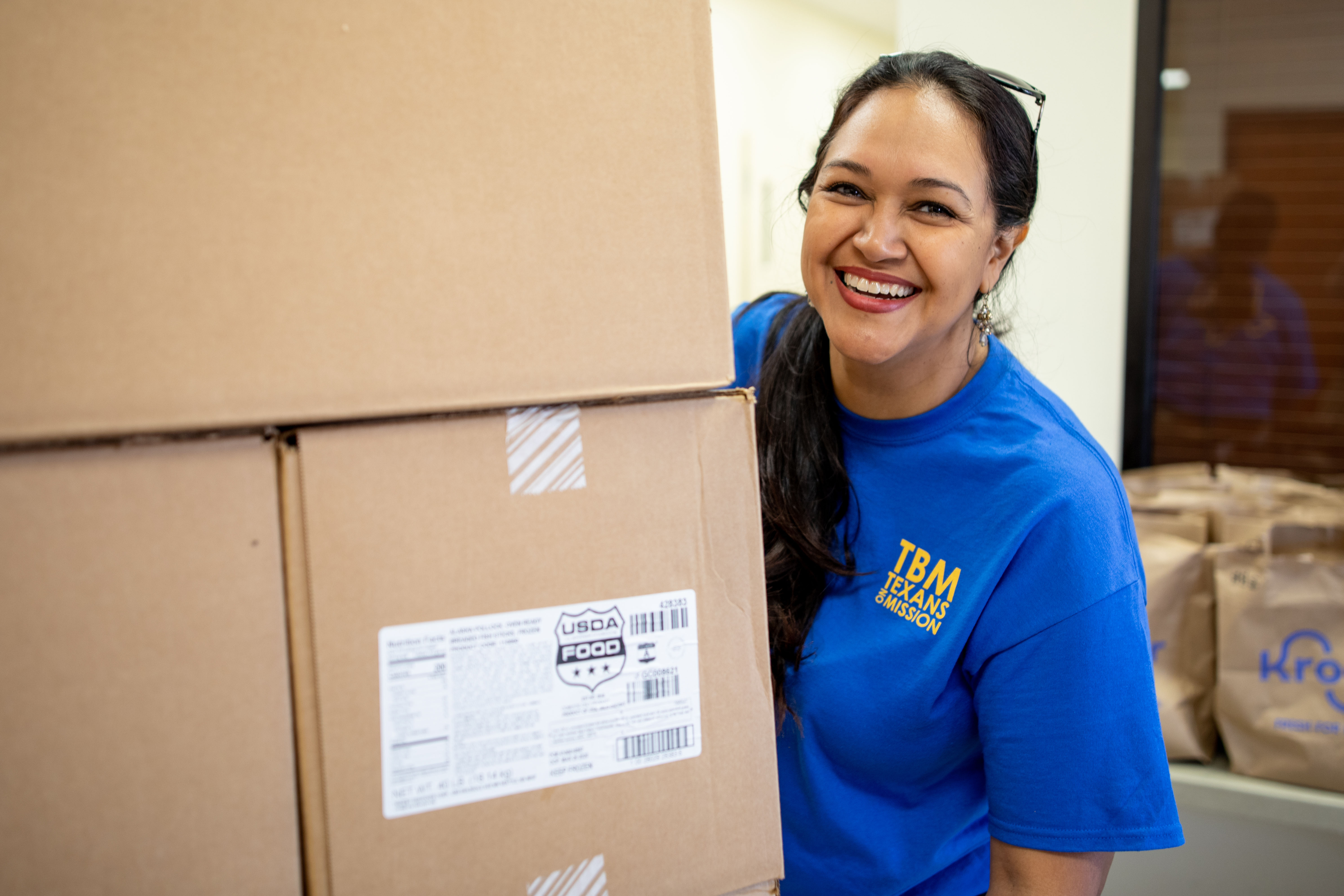 Texas Baptist Men Volunteer Coordinator Sabrina Pinales loads food for a distribution at Bethlehem Baptist Church in Mansfield.