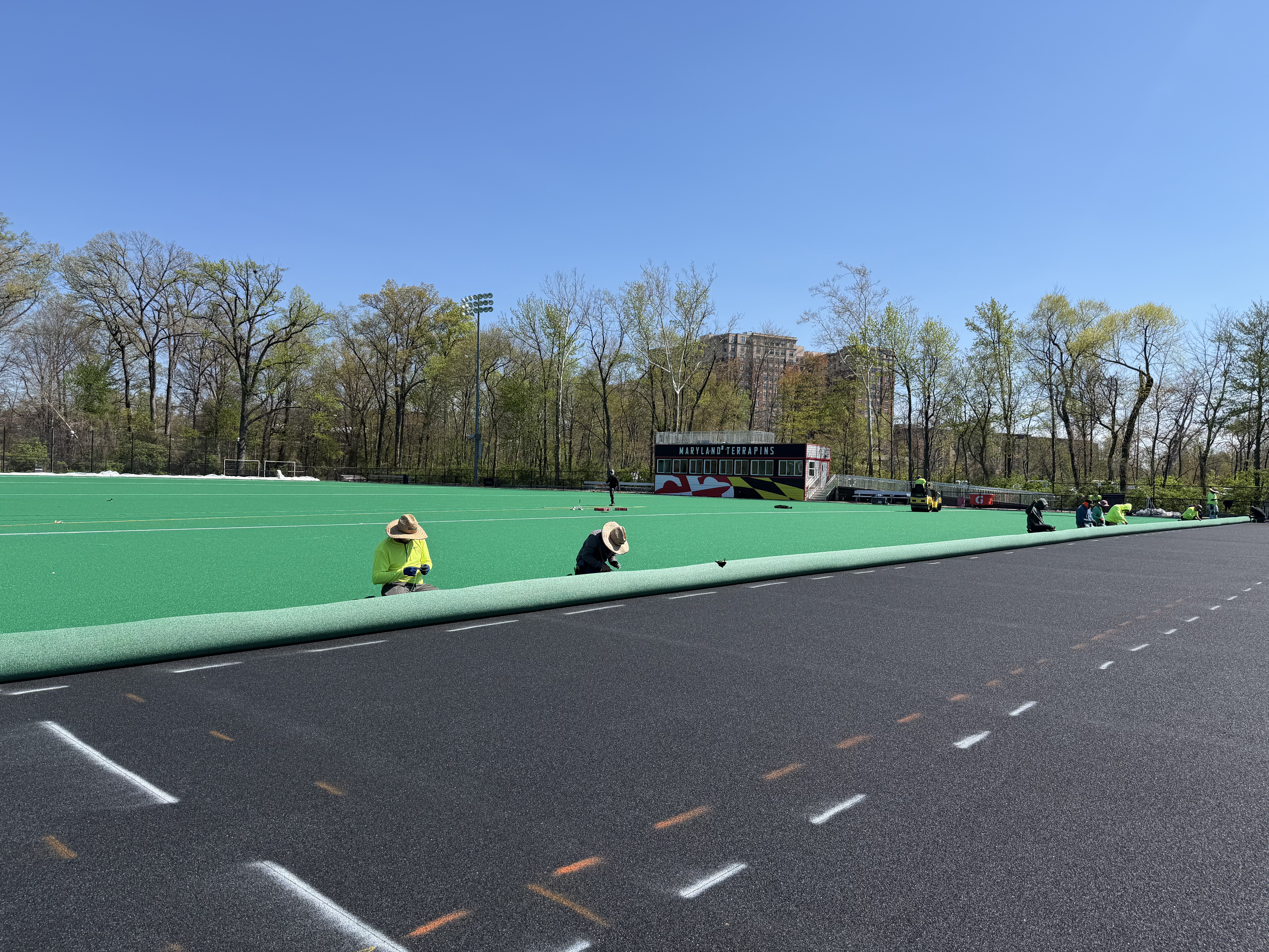 Installers work to Install Updated Astroturf 12 System for University of Maryland Field Hockey