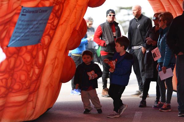 Participants of the St. Louis Undy RunWalk on March 23 tour a giant inflatable colon, part of the Big Colon Tour supported by Olympus. (Photo credit: Marta Payne) 
