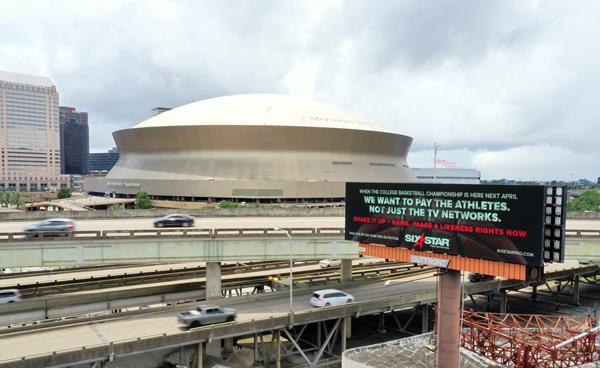 A Six Star Pro Nutrition billboard advocates for student athletes to receive their NIL (Name, Image and Likeness) rights outside of the 2022 College Basketball Championship host venue in New Orleans, Louisiana on June 28, 2021. Photo - Alex Brady for Six Star Pro Nutrition