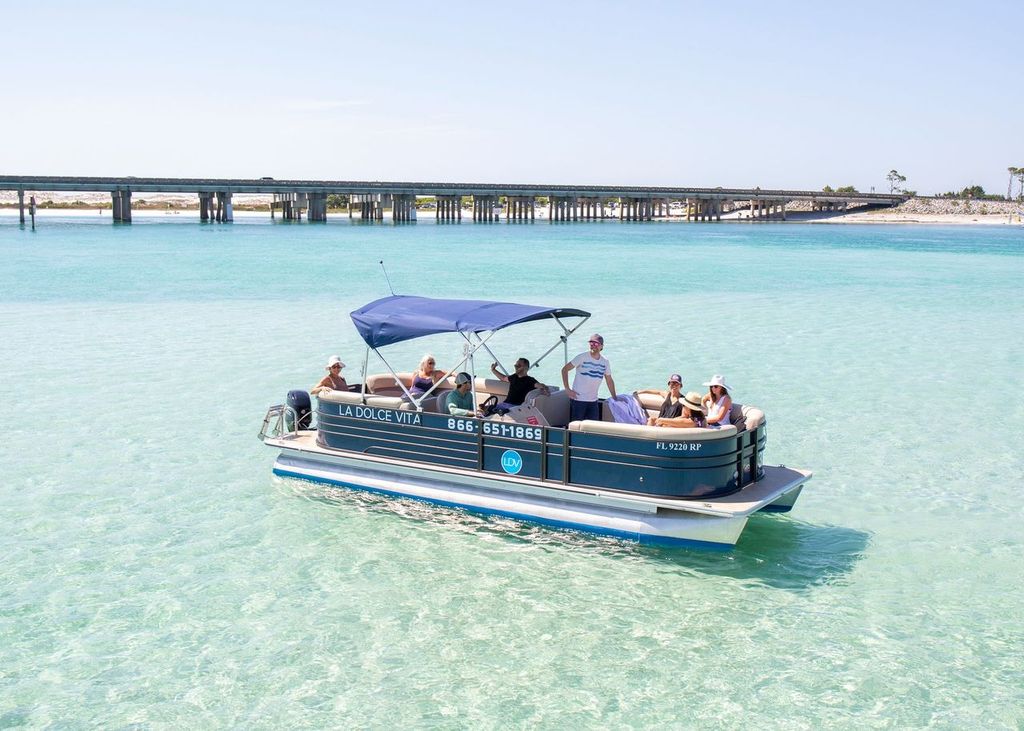 A group of friends on a La Dolce Vita pontoon boat at Crab Island, Destin, promoting water safety and enjoying a sunny day on the water.
