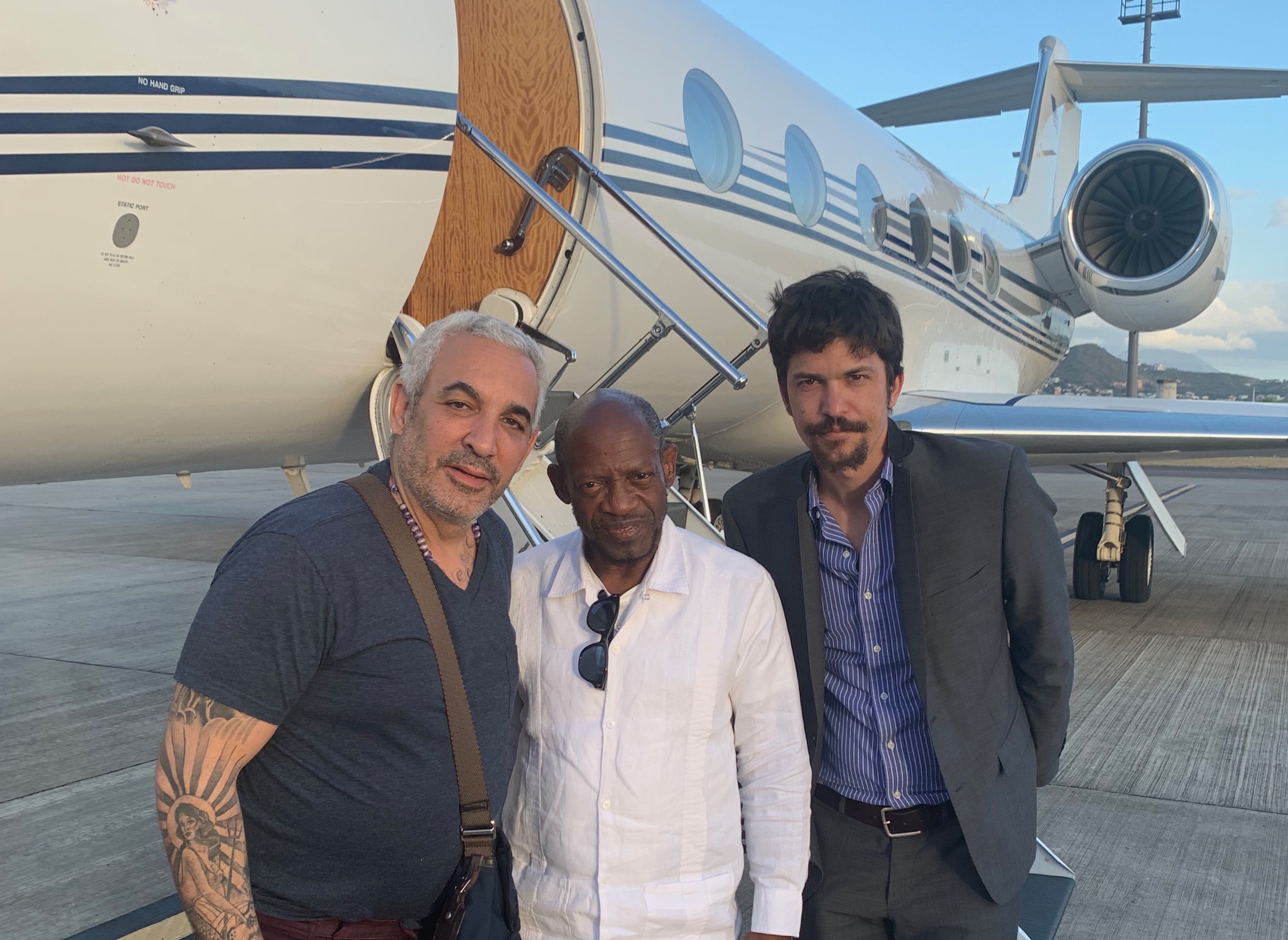 Alki David, four time St. Kitts-Nevis Prime Minister Denzil Douglas, and Chase Ergen on the tarmac in St. Kitts, April 12, 2019. 