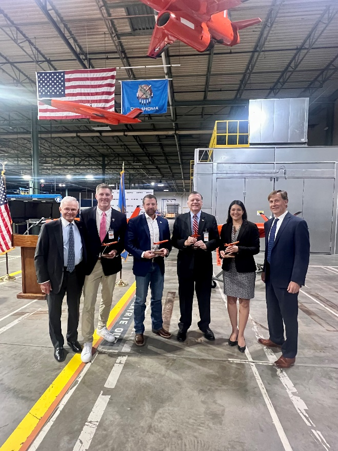 Ben Goodwin of Kratos, Oklahoma Secretary of Military and Veterans Affairs John Nash, Senator Markwayne Mullin (R-OK), Rep. Tom Cole (R-OK-4), Rep. Stephanie Bice (R-OK-5), and Steve Fendley of Kratos Unmanned Systems Division Celebrate 100th Firejet at Oklahoma City Aircraft Manufacturing Facility