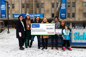 On January 16, 2024, Domenic Primucci, president of Pizza Nova, third from the right, presents a $15,000 cheque to the SickKids Foundation.