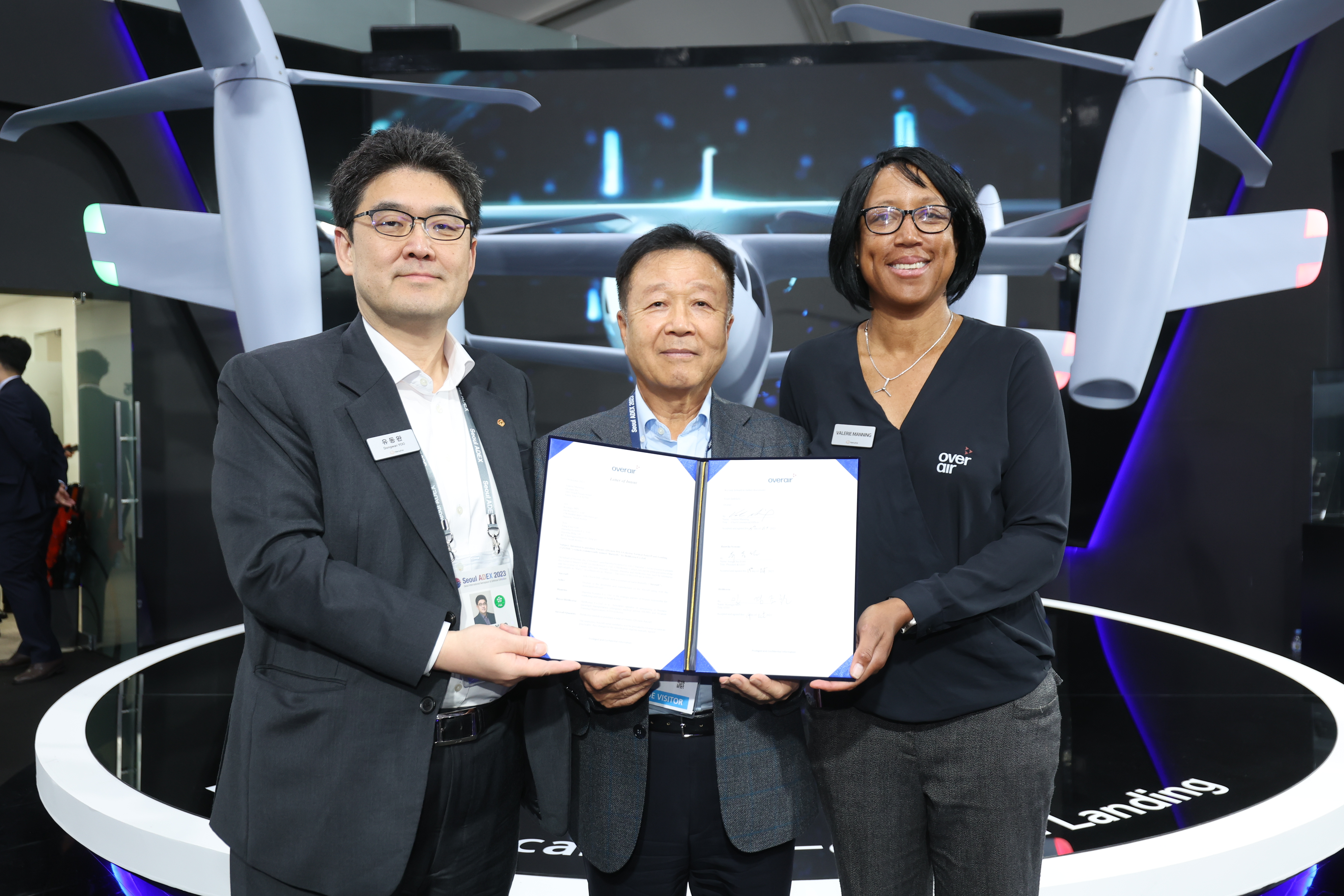 Company leadership from Overair, Hanwha Systems and Heli Korea stand with letter of intent document