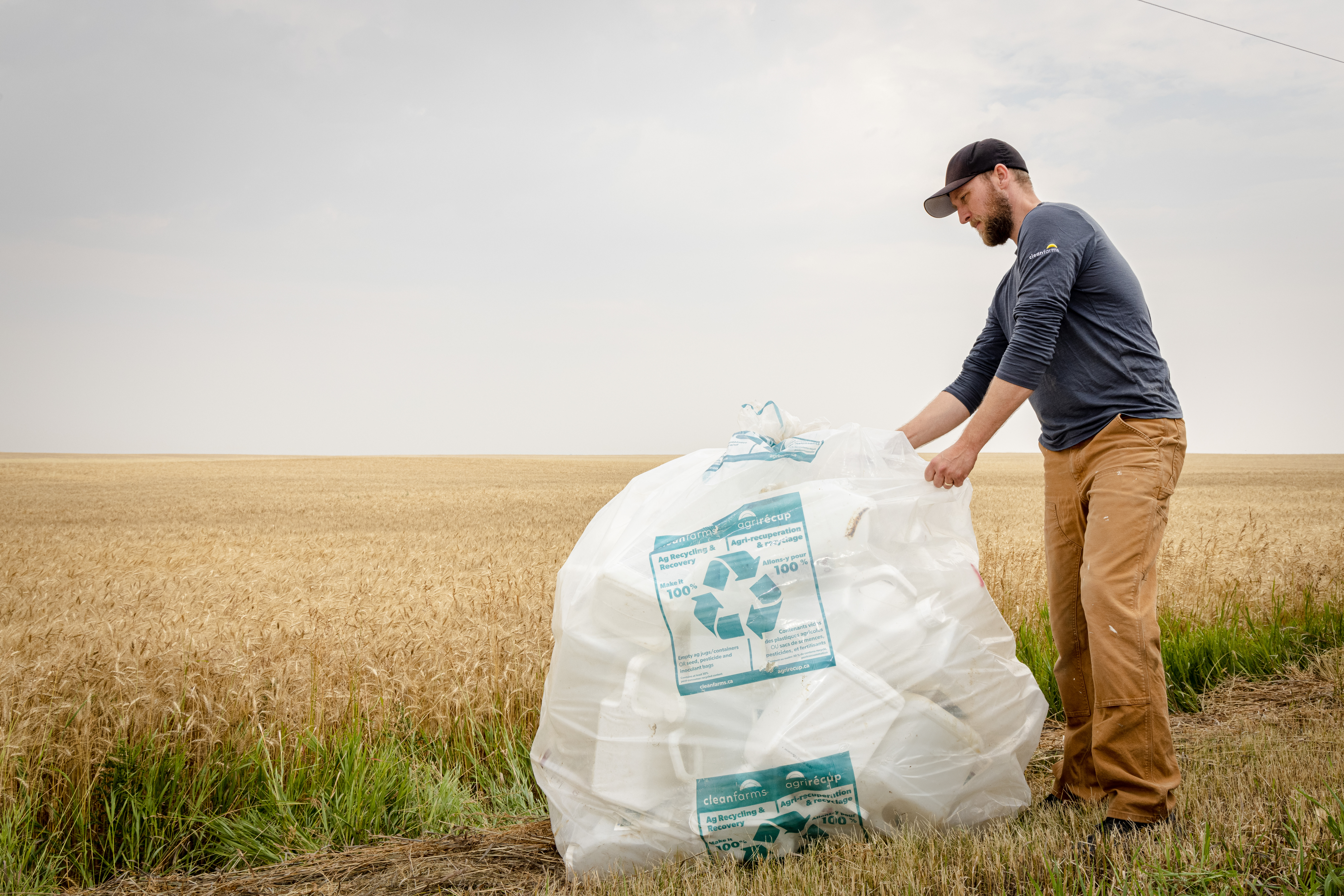 Pesticide and fertilizer containers under 23L, prepared for drop-off at a collection site to be recycled.