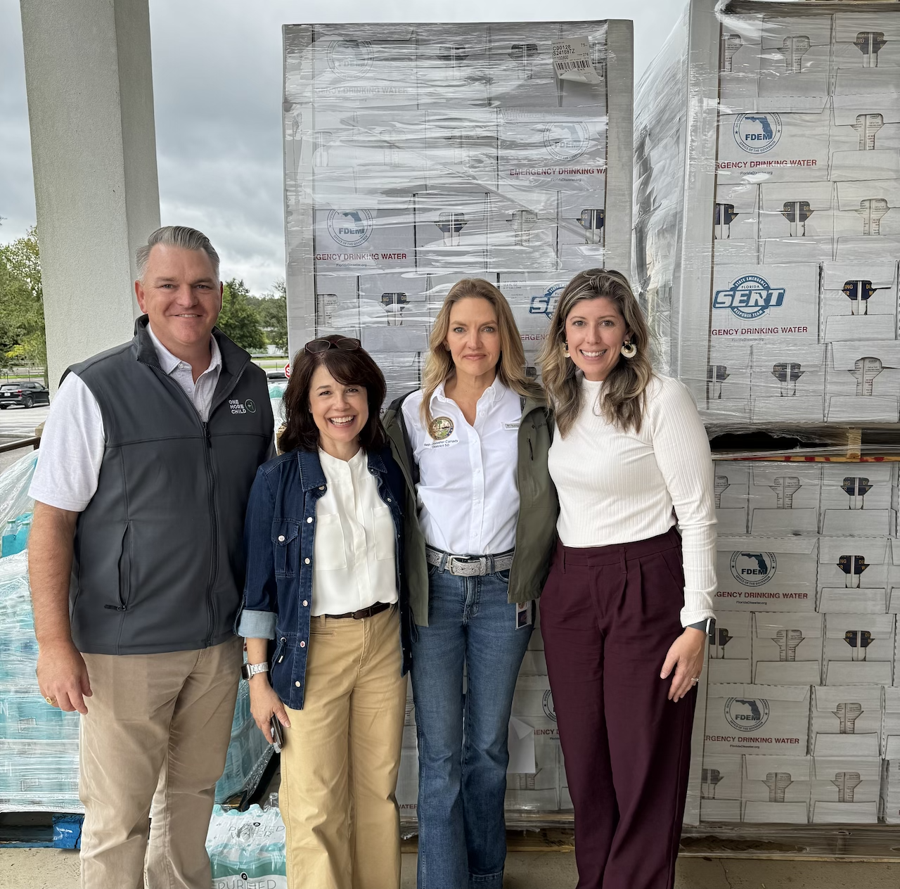 One More Child prepares to distribute food, water, diapers, tarps, cleaning supplies and other essential items to communities hardest hit by hurricanes. (Pictured L-R) Chief Operating Officer Stephen Robert, Senior Director of Operations Heather Bryant, Florida State Representative Jennifer Canady and Vice President of Program Operations and Public Policy Jodi Domangue.