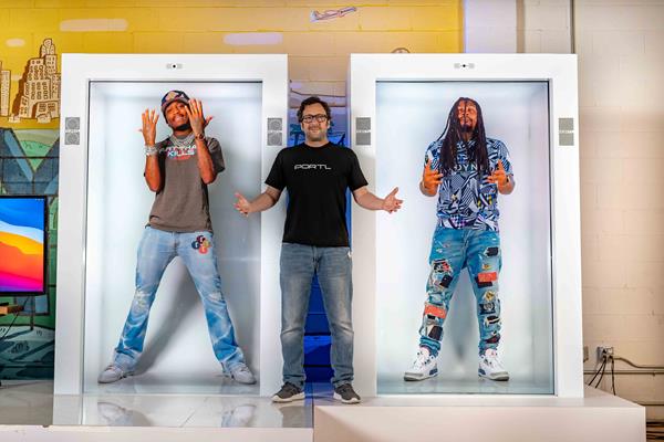 PORTL CEO David Nussbaum (center) with hologram investors Quavo (left) and Marshawn Lynch (right)