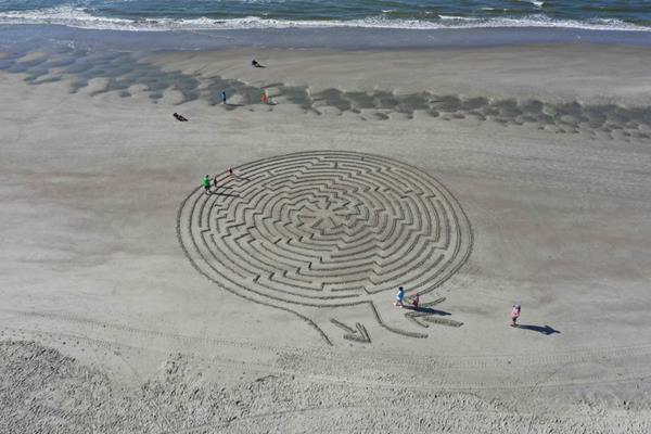 Hunter Gibbes, known as the Sunset Beach Maze Man, creates larger-than-life mazes on the beach for both locals and visitors to enjoy. Photo Credit: the Sunset Beach Maze Man