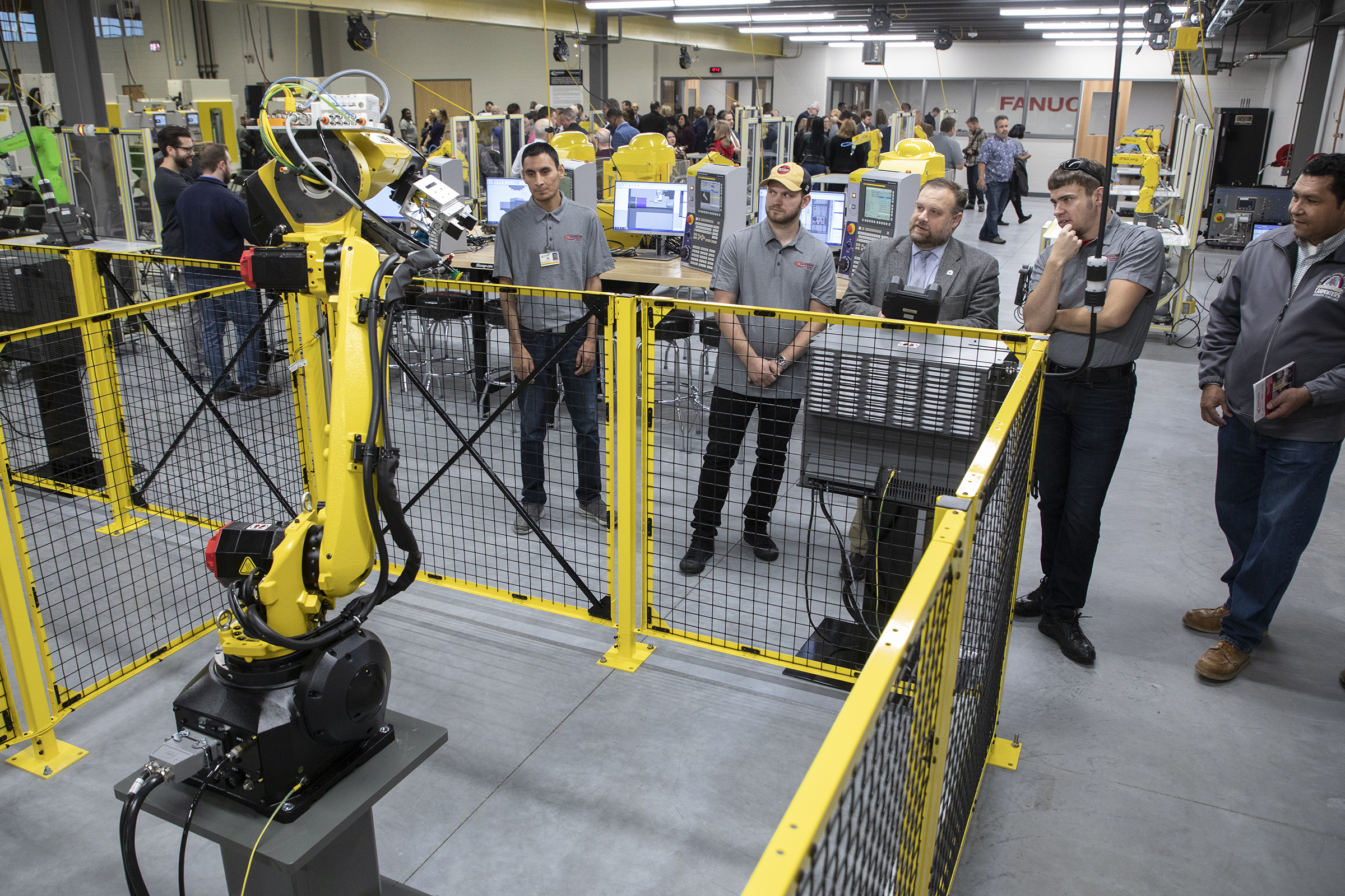 Racine, Wis., Mayor Cory Mason tries out one of the industrial robots at the opening ceremony for the remodeled and expanded Gateway Technical College SC Johnson iMET Center in Sturtevant Wis., Oct. 22, 2019. Many national companies stepped forward to help make the center a success, such as FANUC America's robot systems in the center.