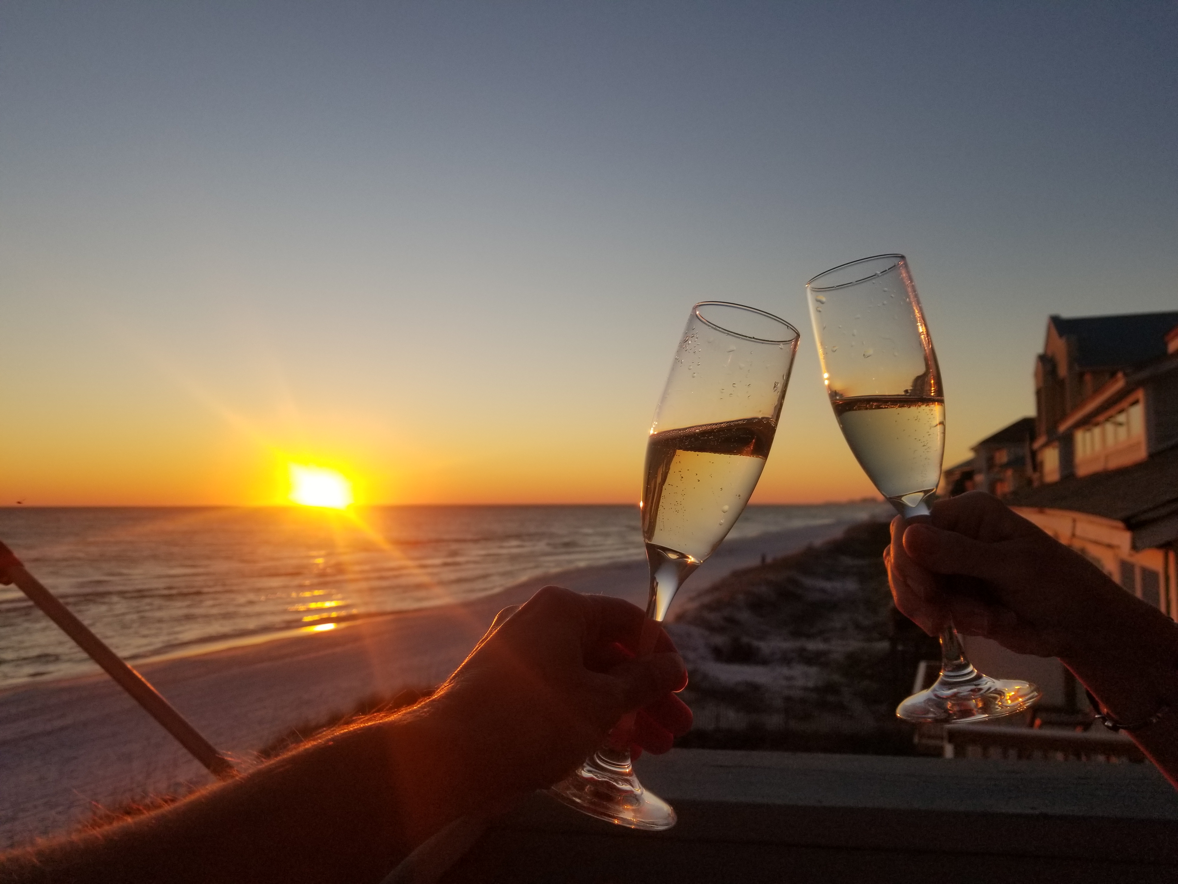 Friends toast the New Year from their vacation rental overlooking Destin's pristine beaches