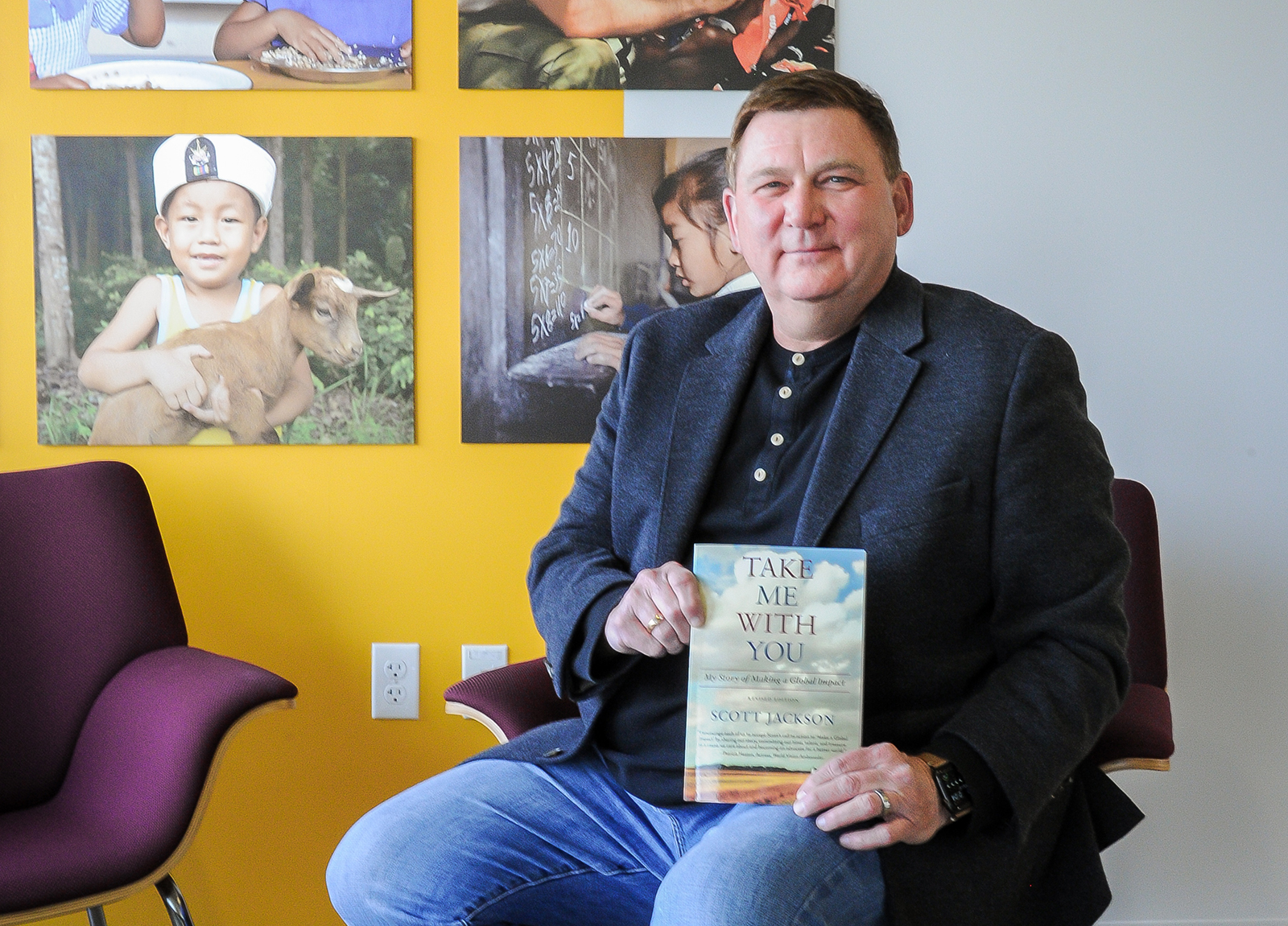 Scott Jackson with his rereleased book, "Take Me With You"