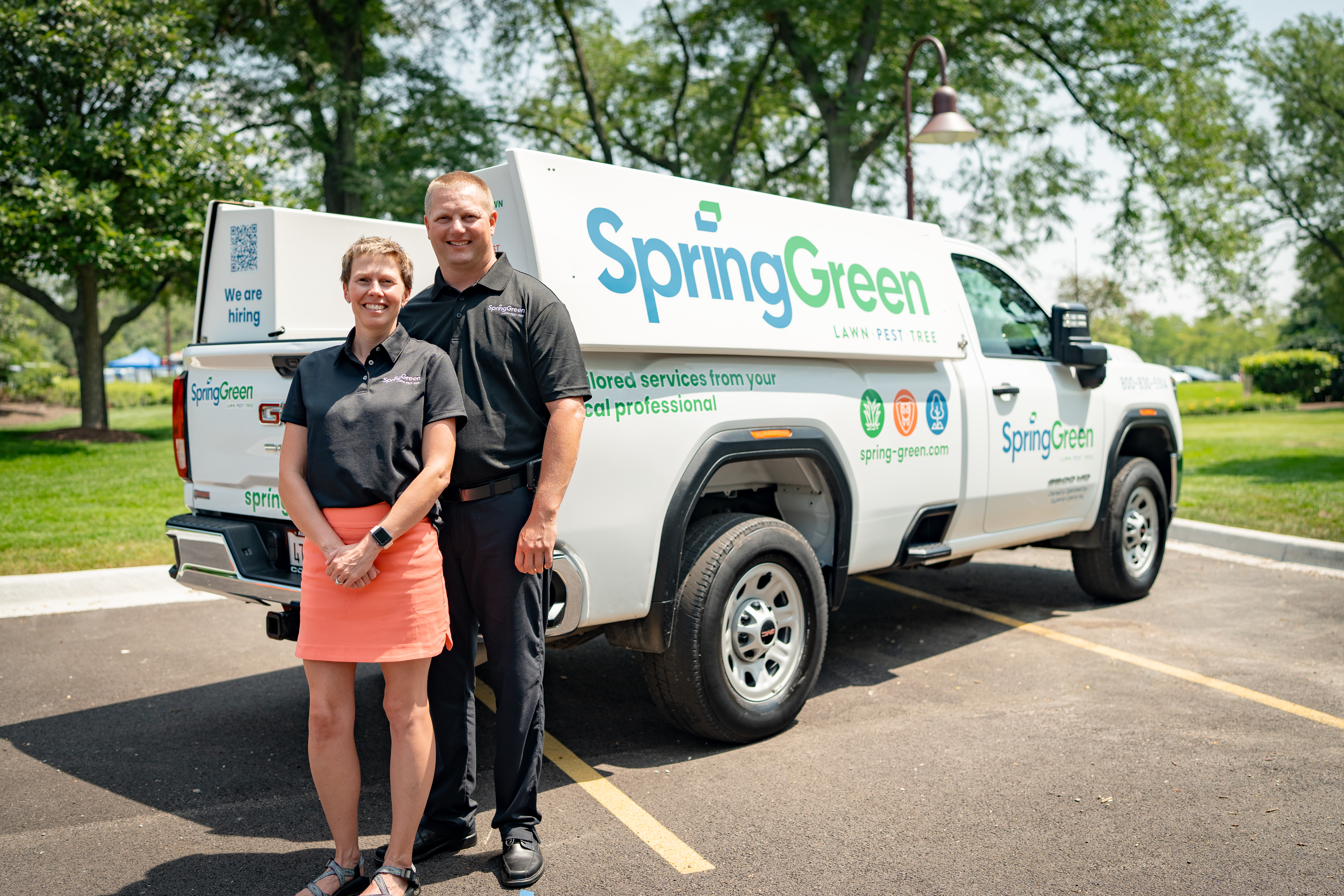 Marty and Kelly Amundson standing with their SpringGreen service truck in Rochester, Minnesota after renewing their franchise