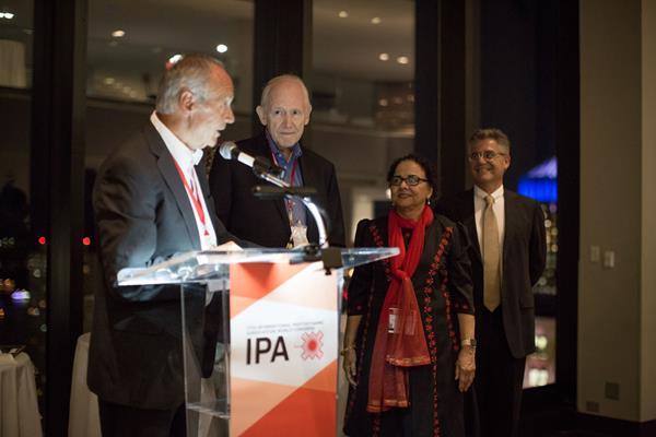 Dr. Charles Gomer (center) receiving his Gold Medal award from Dr. Herwig Kostron (left), IPA Past-President, Dr. Tayyaba Hassan (right), and IPA President, Dr. Luis Arnaut (far-right)