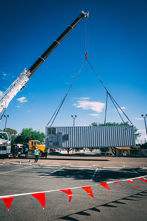 Designed as a self-contained, integrated, automated disinfected mobile military resuscitation, surgery and post-op/ICU unit, the Clean Cube, is shown being lifted into place.