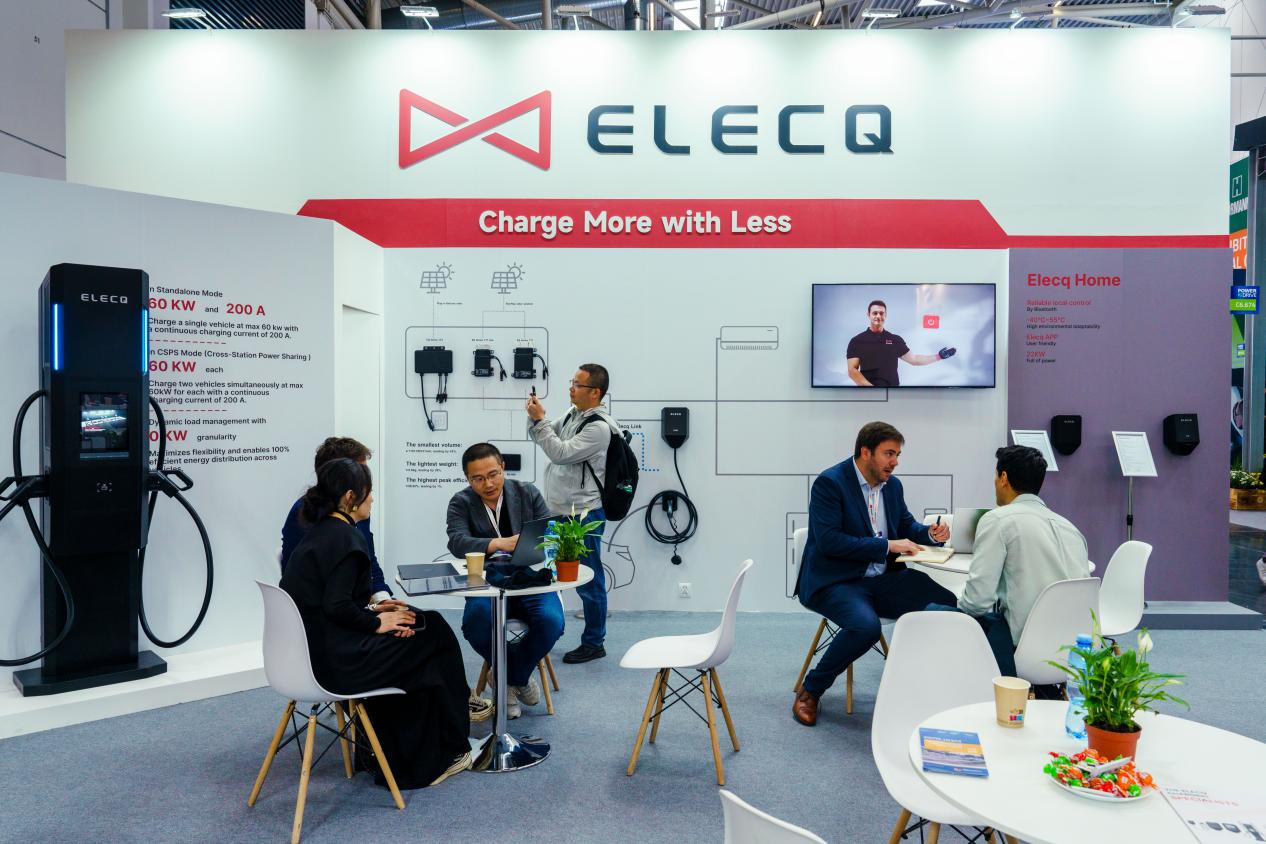 ELECQ sales representatives speaking with attendees at Power2Drive Europe 2025, exchanging ideas on EV charging technologies and sustainable energy so