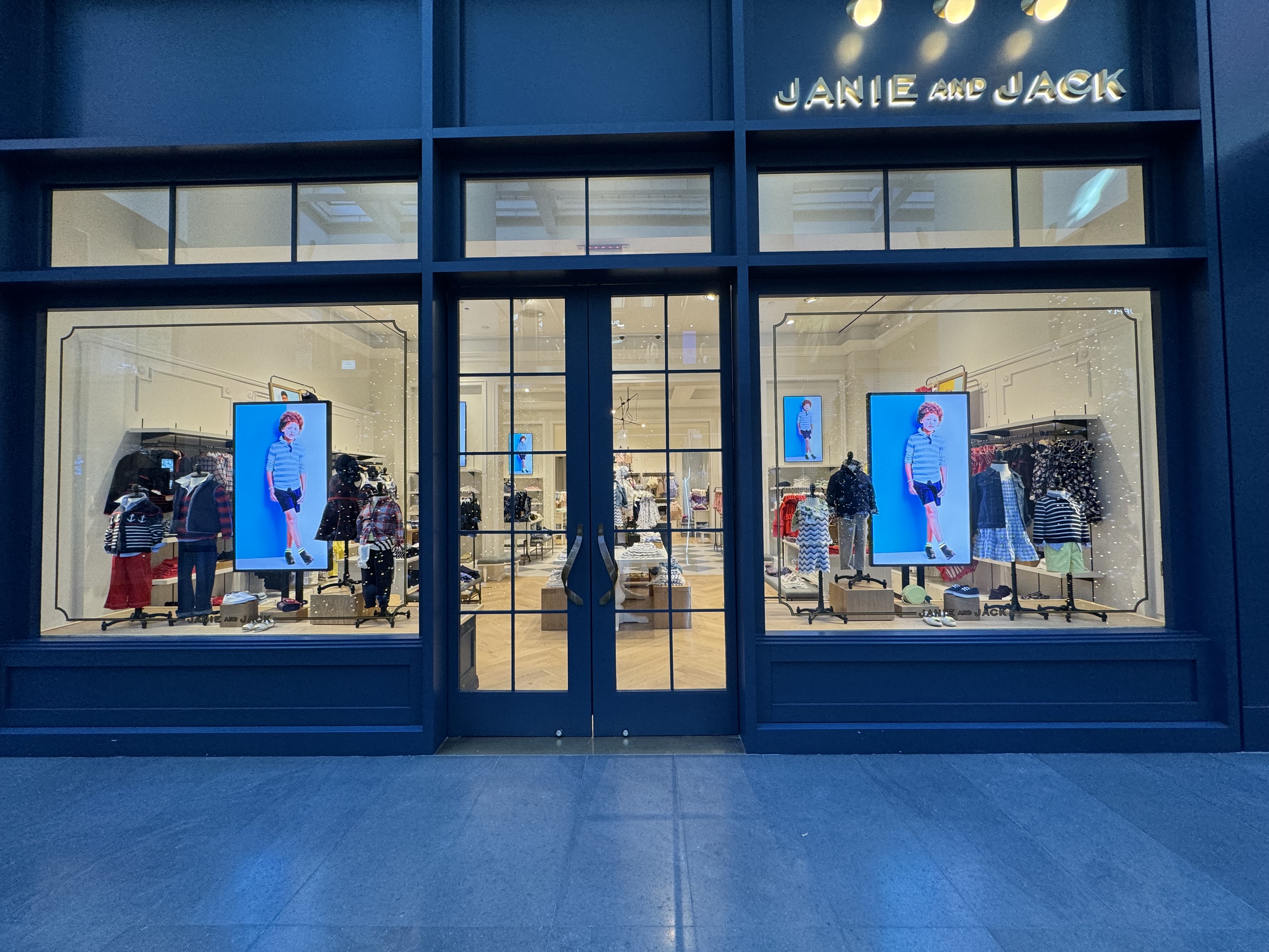 Janie and Jack mall storefront with Samsung 4K window displays and seasonal content