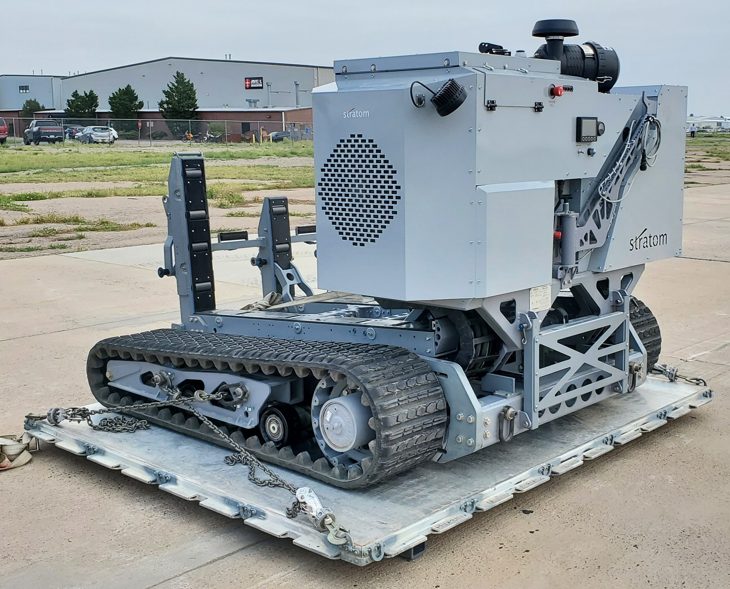 Stratom eXpeditionary Cargo Loader (XCL) is a tethered remote control material handling system capable of moving up to 10,000 pounds of cargo while occupying a single 463L pallet position on a C-130 aircraft.