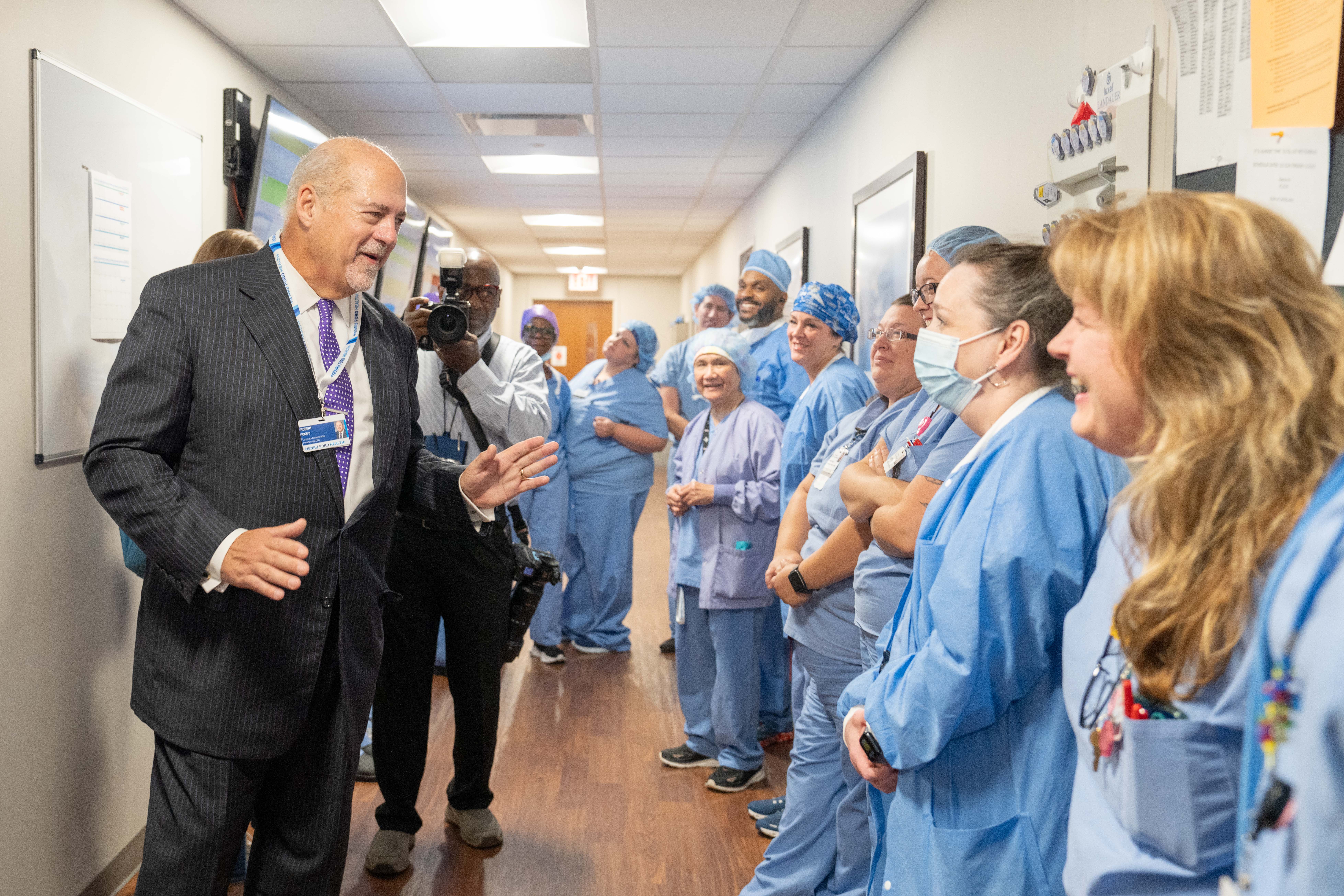 Henry Ford Health President & CEO Bob Riney greets team members at the newly-renamed Henry Ford St. John Hospital in Detroit. The hospital on Moross Road in Detroit is among the 13 acute care hospitals and three behavioral health facilities now under the Henry Ford Health umbrella.