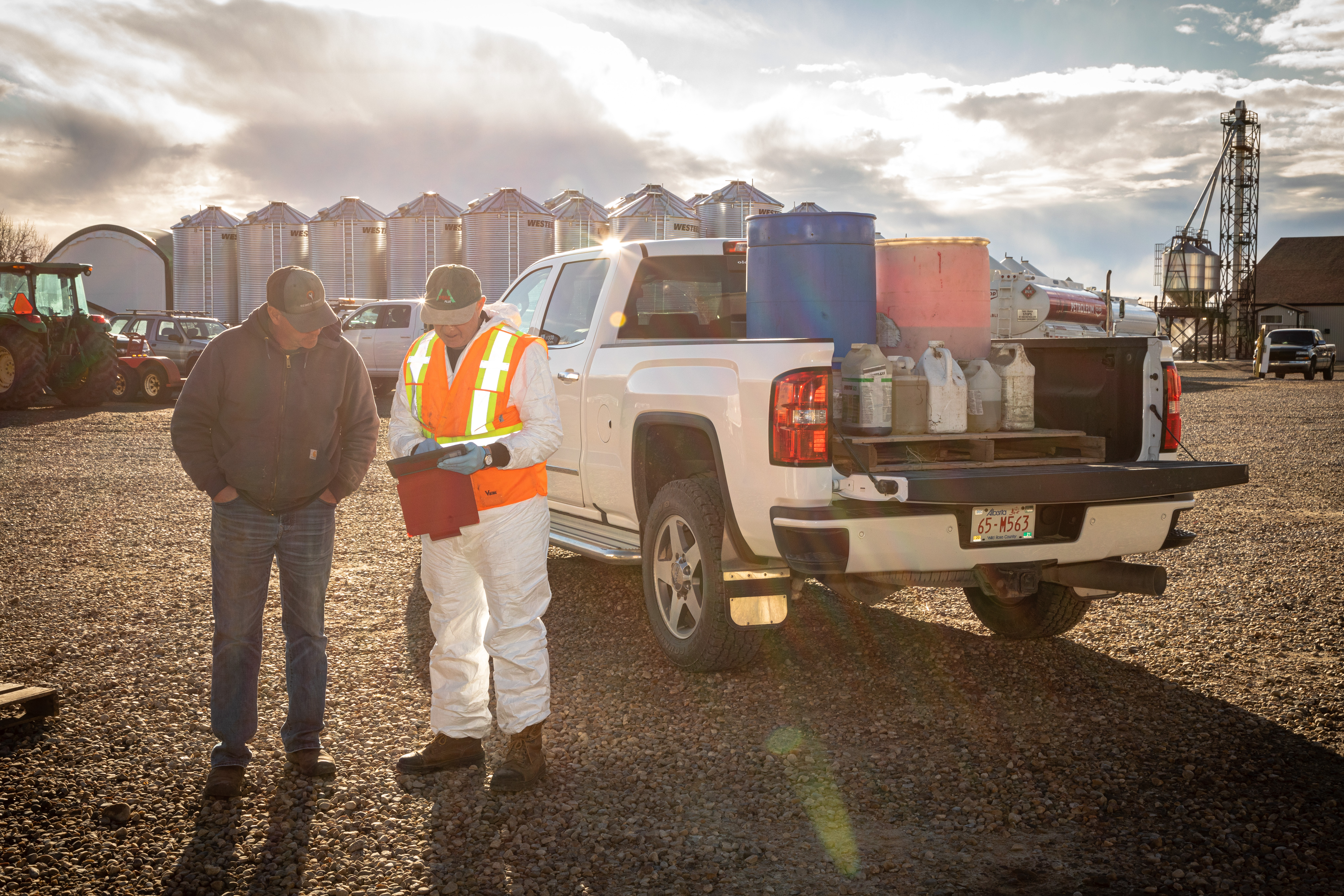 Unwanted pesticides and old livestock medications being dropped off and sorted at a collection site for safe disposal.