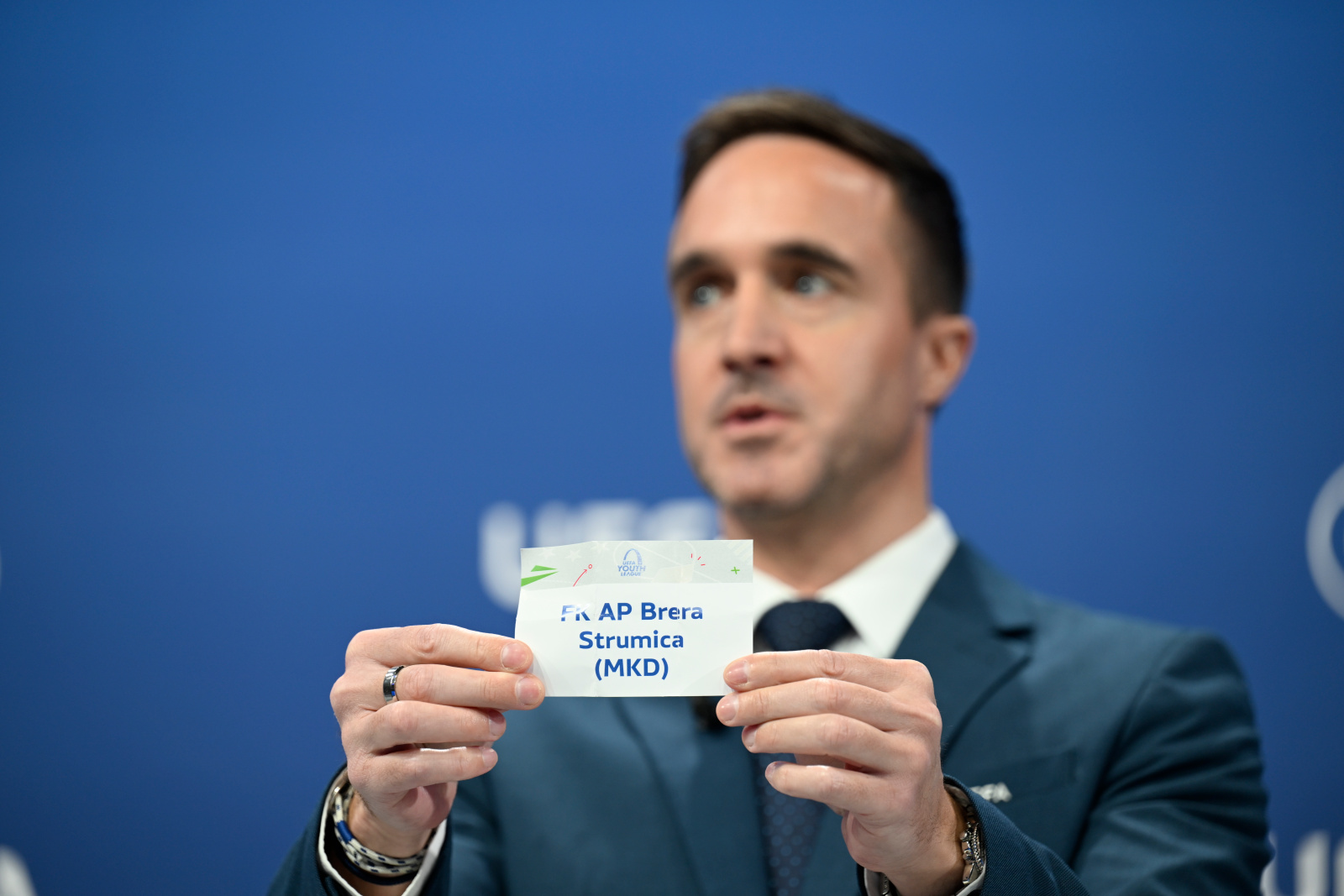 UEFA Senior Club Competitions Manager Tom Barlow draws out the card of FK AP Brera Strumica