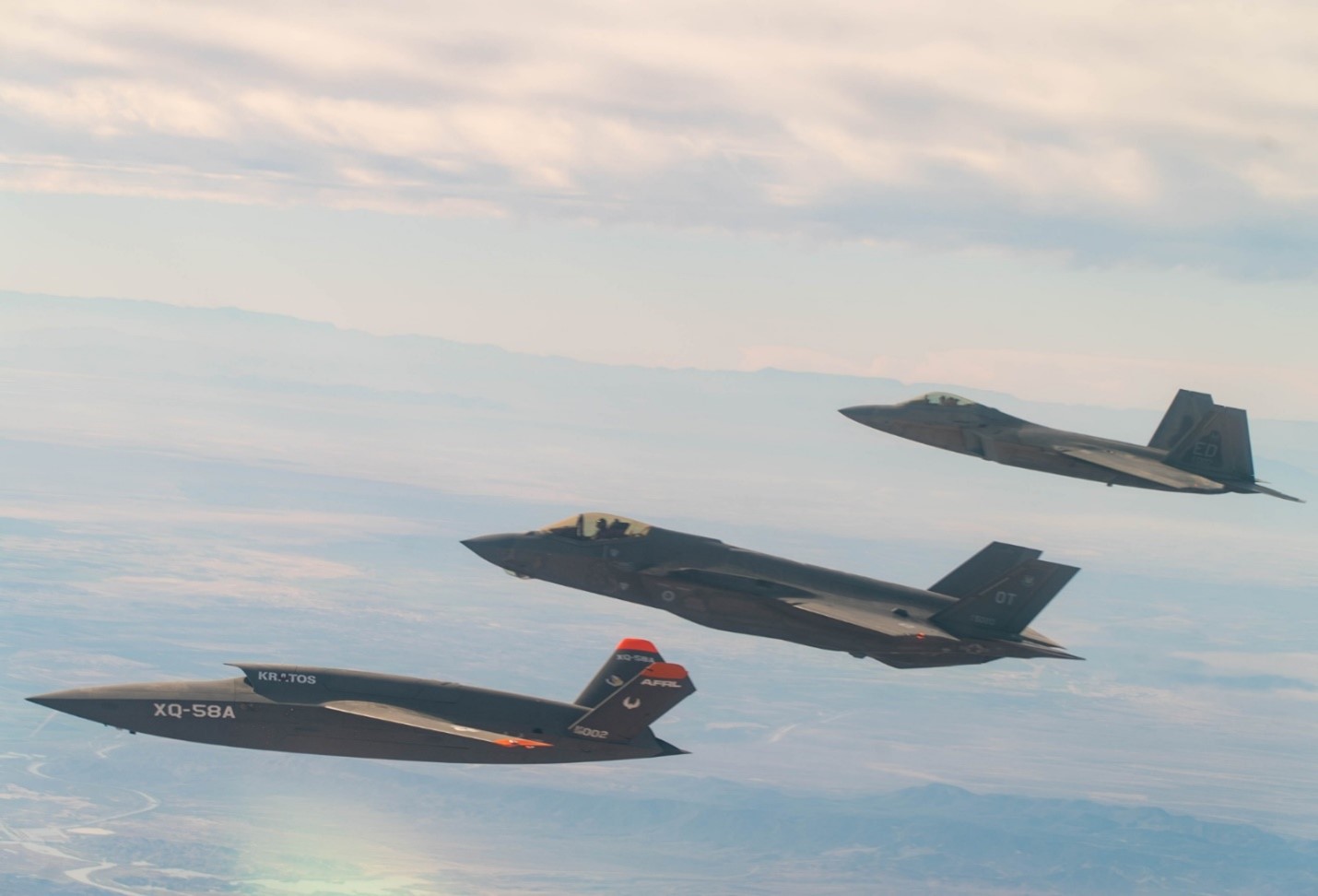 XQ-58A Valkyrie, F-35 Lightning II, and F-22 Raptor