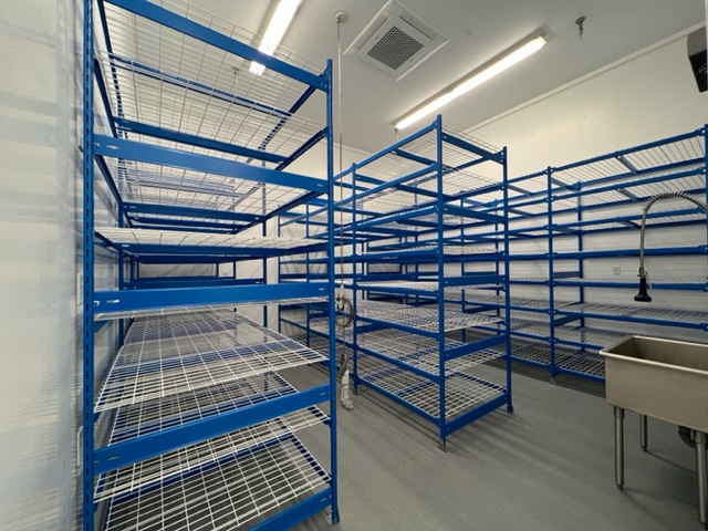 Ten foot shelving racks in Optimi's fruiting chamber.