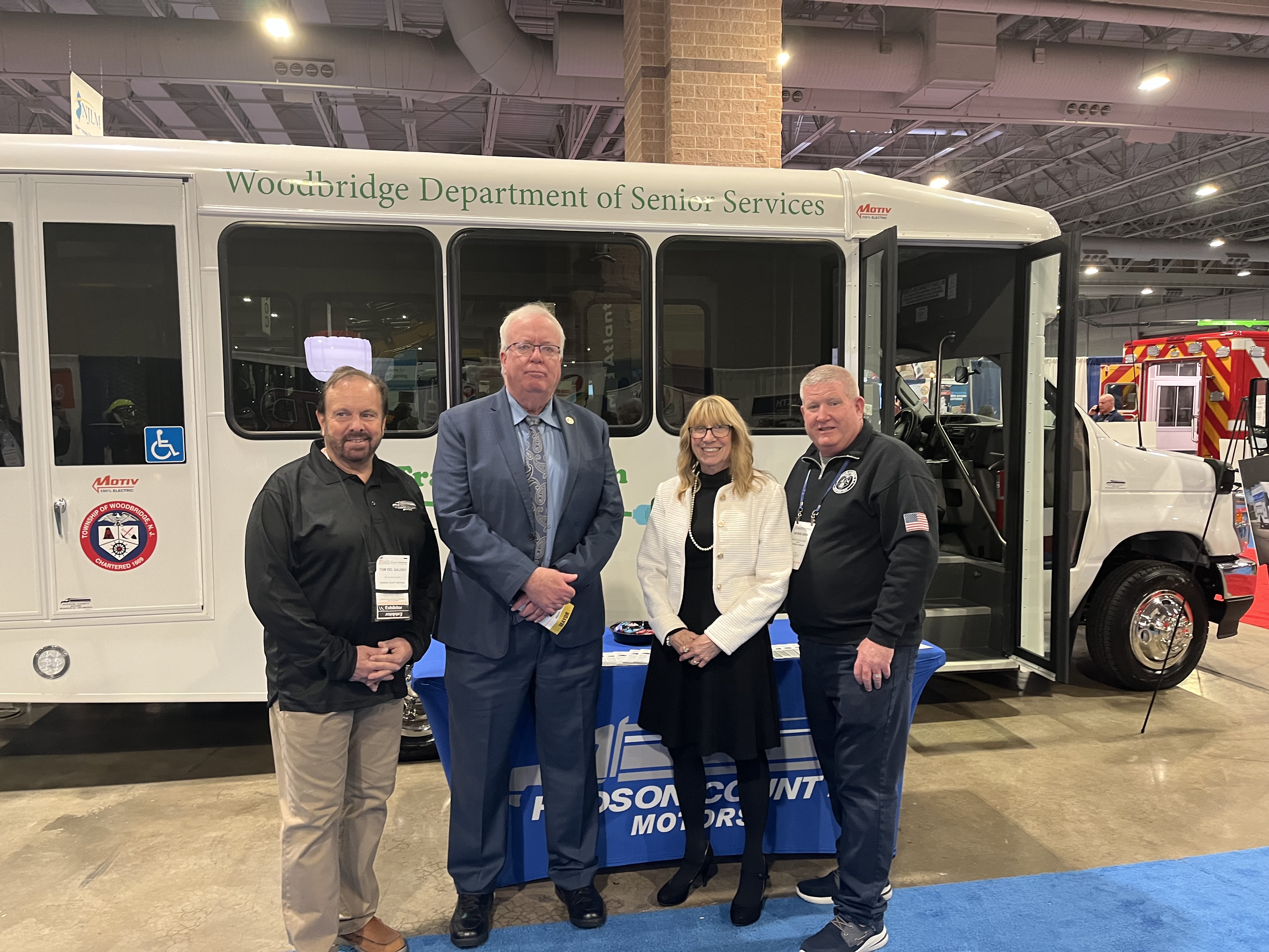 Township of Woodbridge leaders in front of Motiv electric shuttle bus