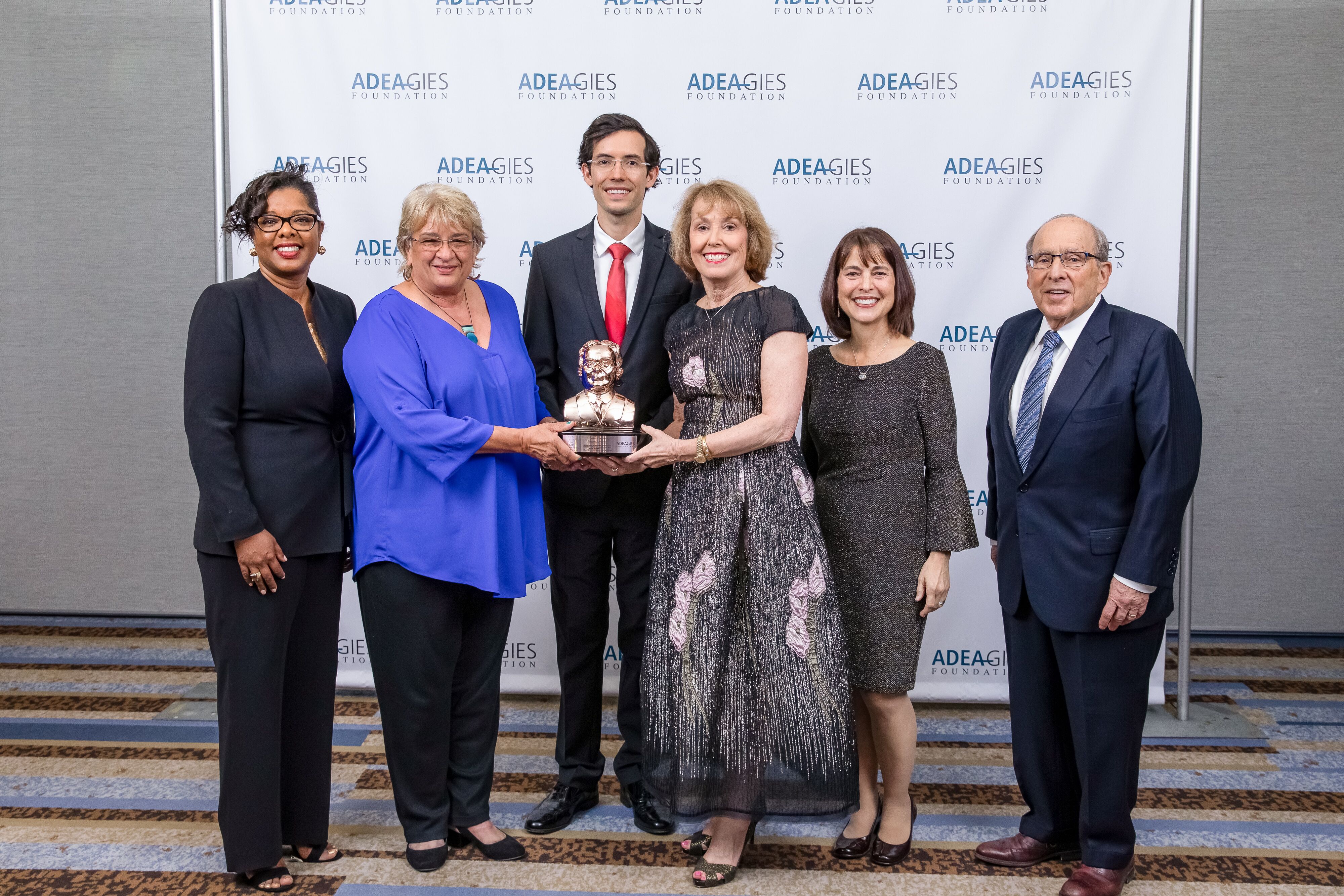 Accepting the Gies Award are, from left, Delia Celestine, M.P.H. Ed.D., assistant dean, student and alumni affairs, Dr. Kiran C. Patel College of Osteopathic Medicine; Elaine Wallace, D.O., dean, Dr. Kiran C. Patel College of Osteopathic Medicine; Aaron Goodwin, D.O., D.M.D., 2015 graduate of the D.O./D.M.D. program; Linda C. Niessen, D.M.D., M.P.H., dean and professor, College of Dental Medicine; Abby Brodie, D.M.D., M.S., associate dean for academic affairs, College of Dental Medicine; and Bruce Donoff, D.M.D., M.D., dean and professor, Harvard School of Dental Medicine who introduced the NSU team.