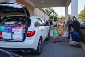 Five-year-old T.J. Moreno arrives at One More Child's headquarters in Lakeland, Florida, with three carloads of diapers
