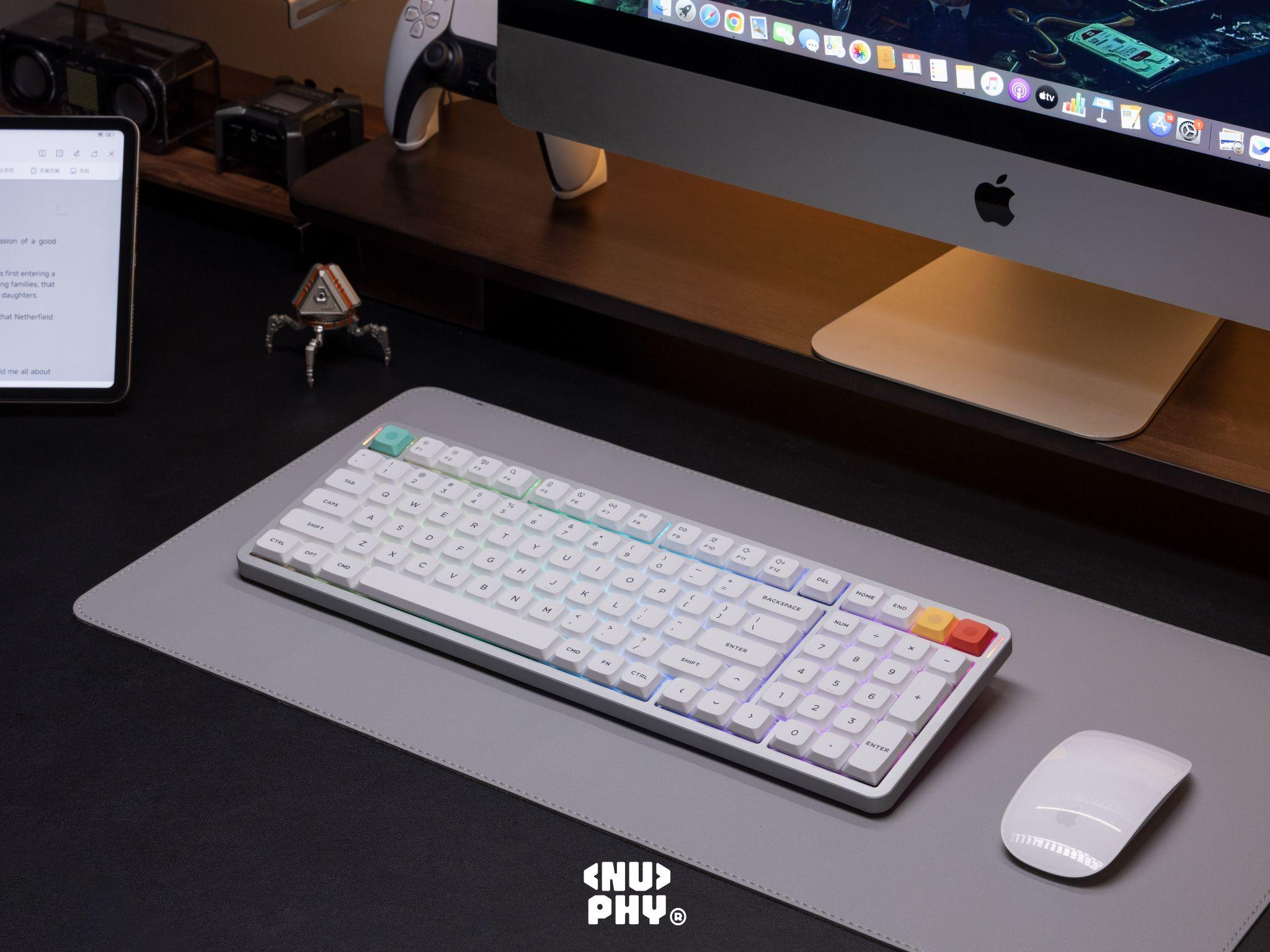 NuPhy Air V3 full-size keyboard in a desktop workspace setup with iMac and accessories