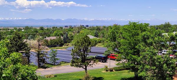 A view of the Oxford Vista solar field with a backdrop of the Colorado mountain range.