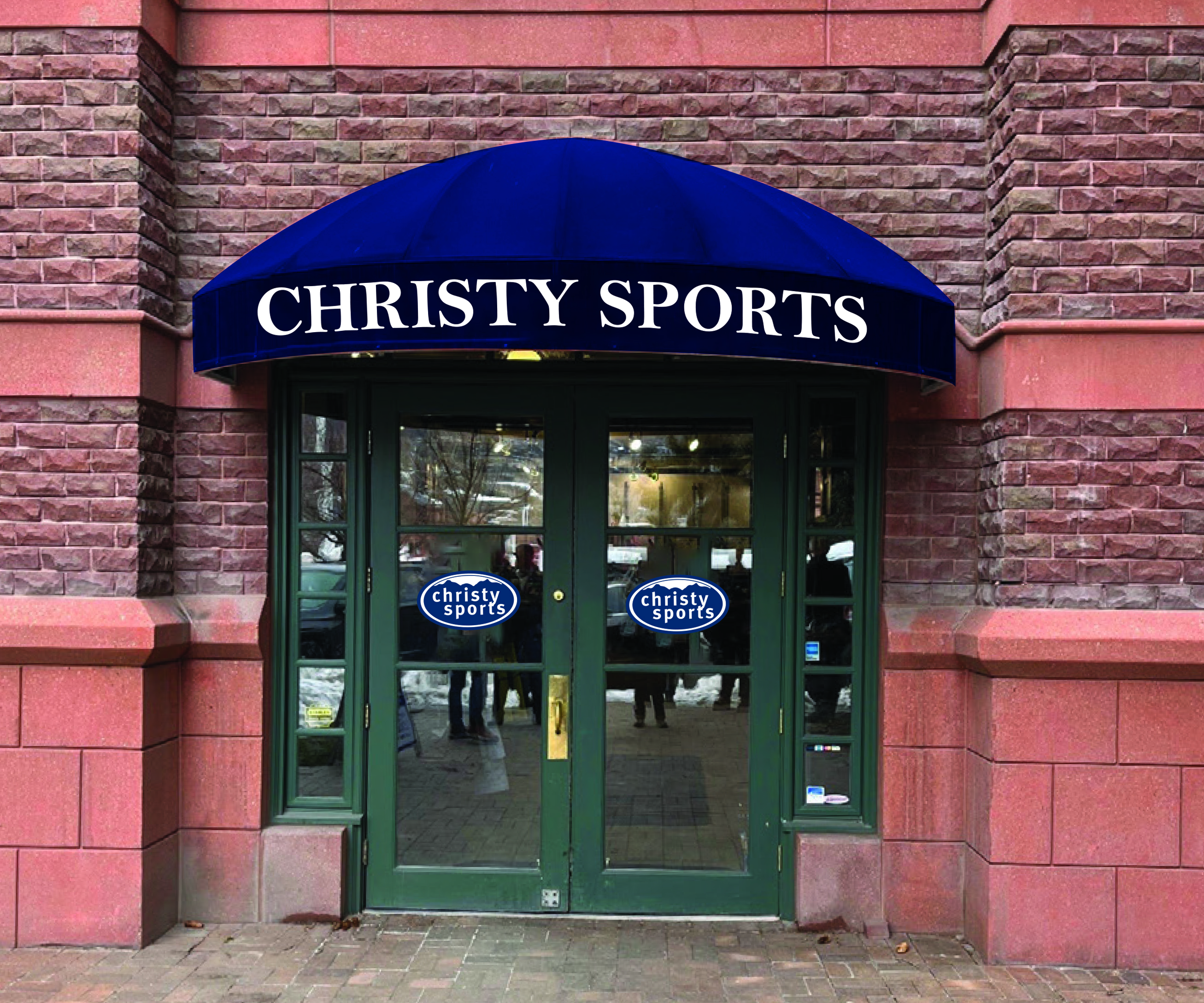 Store entrance of new Christy Sports store in Aspen, Colorado at St. Regis Resort blue awning above store entrance that reads Christy Sports