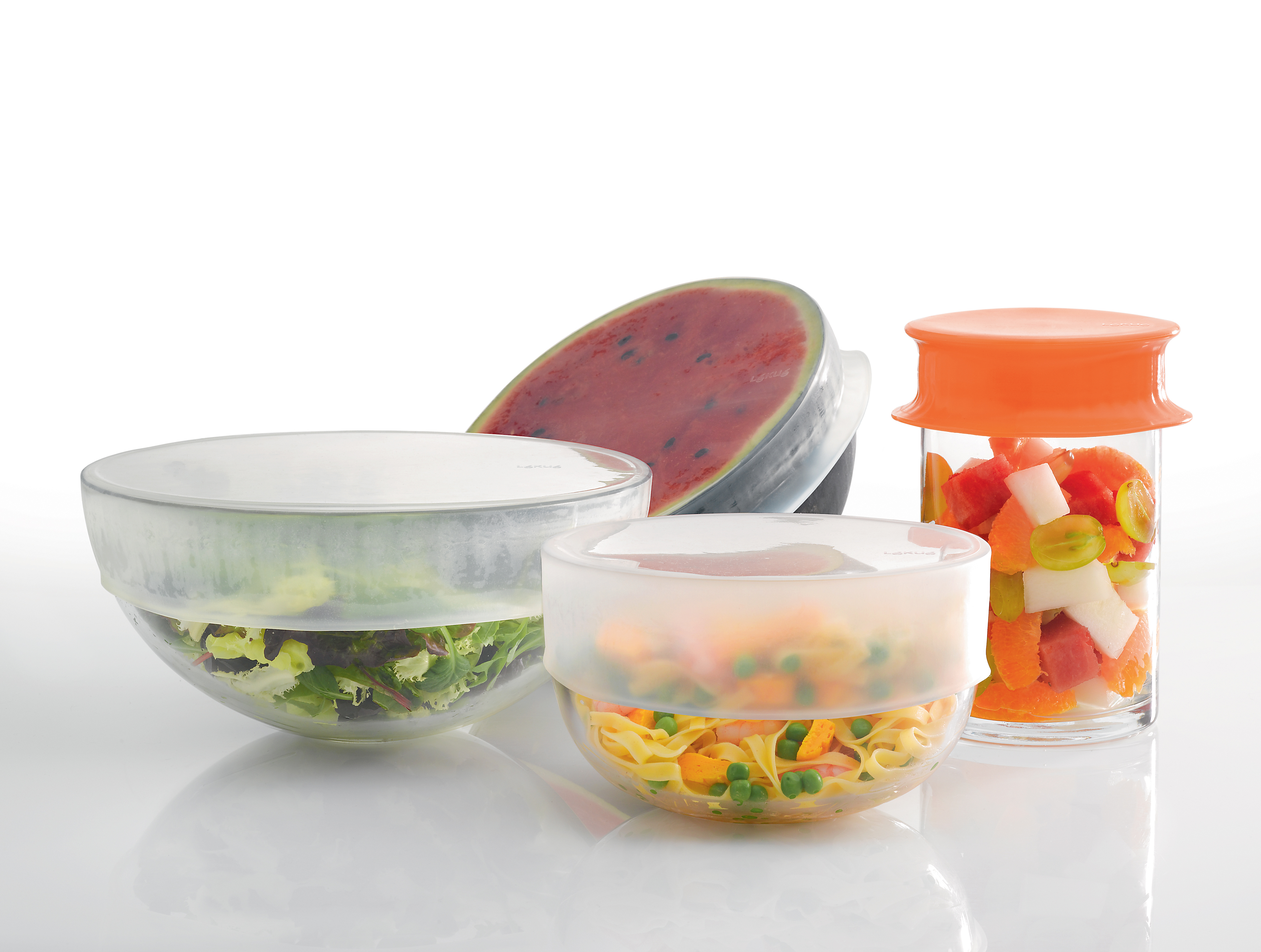 Lékué stretch top lids fit over containers of varying sizes and around foods.
