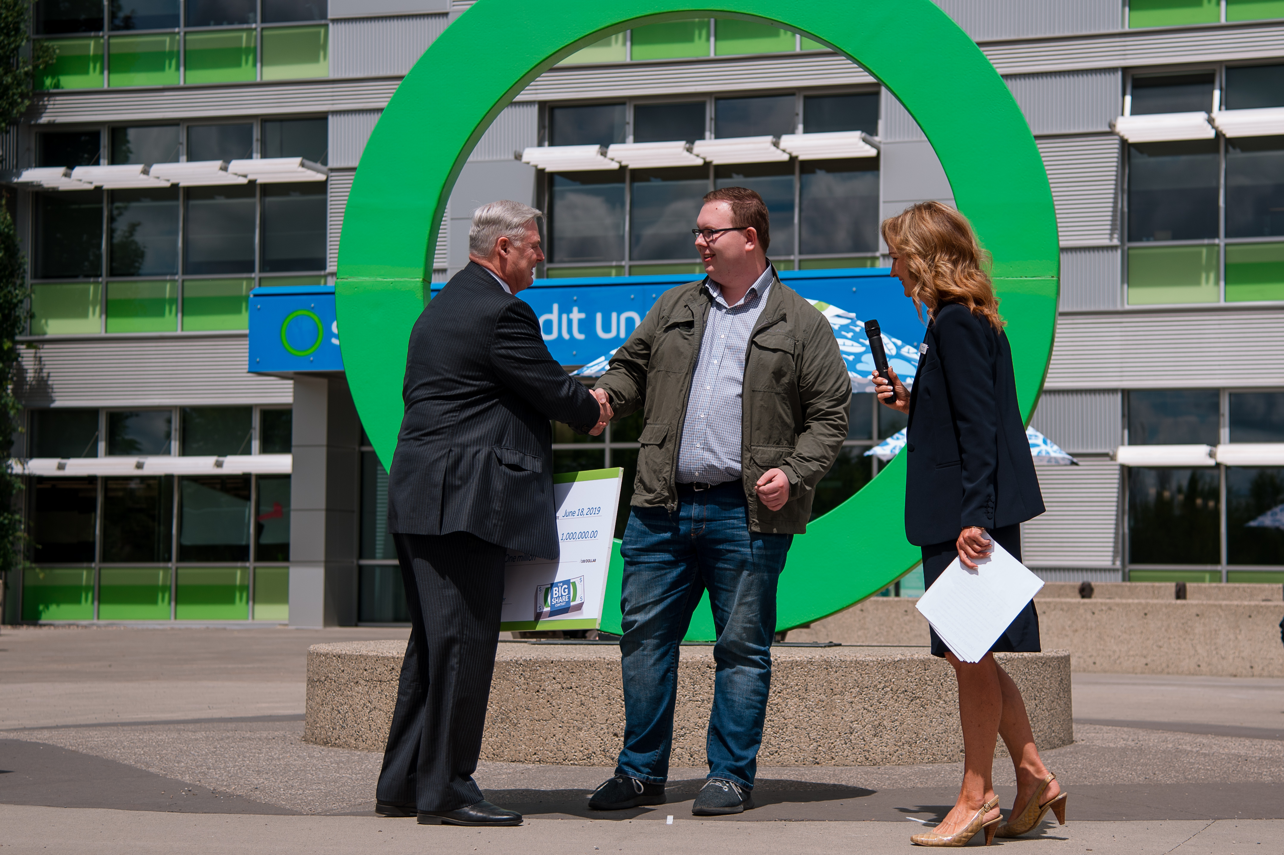 Garth Warner - CEO of Servus Credit Union - Congratulating Andrew Buchner the million dollar winner of the Big Share contest