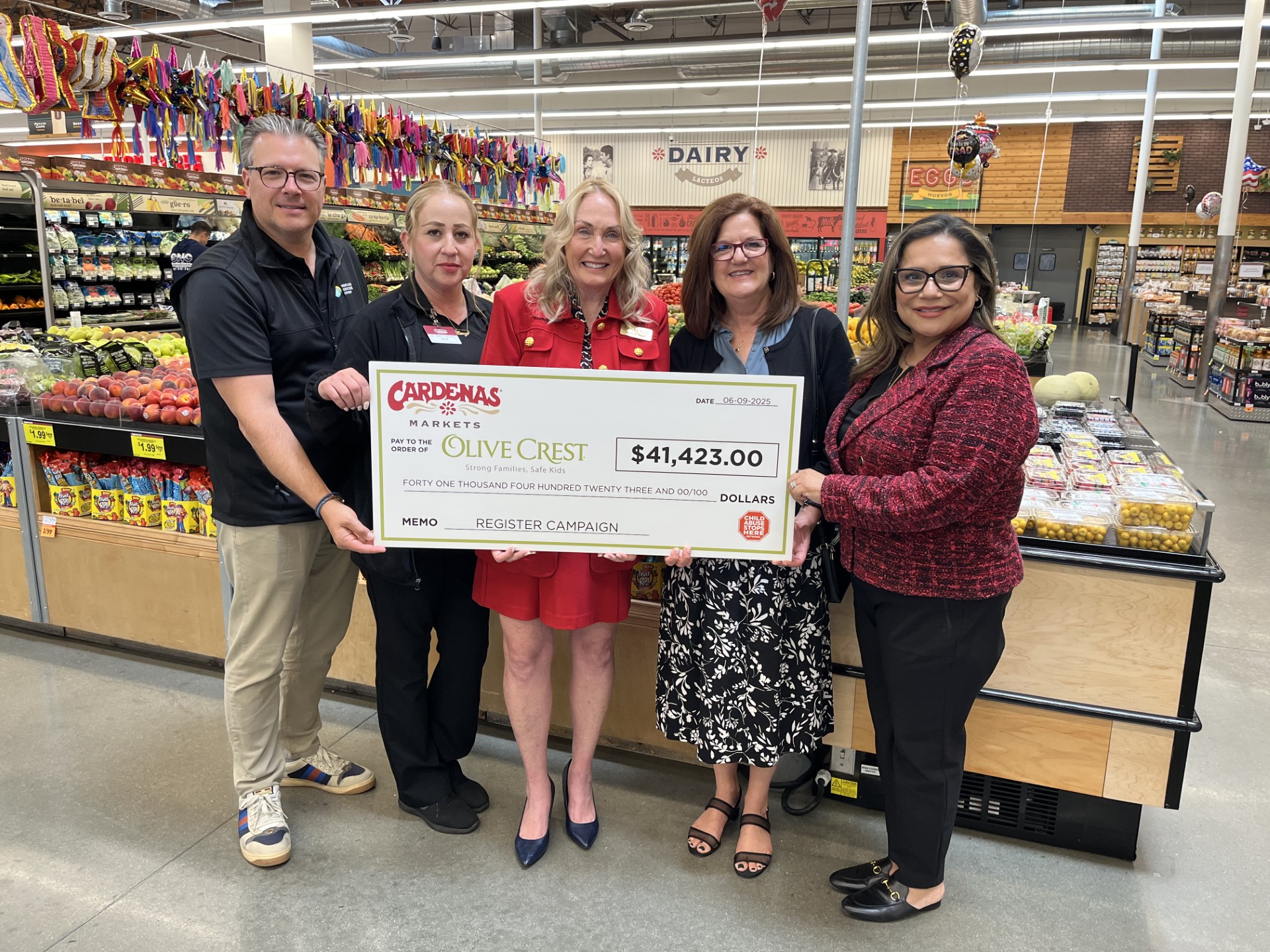 Heritage Grocers Giving Foundation board members proudly present funds raised by Cardenas Markets to Olive Crest representatives celebrating a shared commitment to uplifting children and families in need