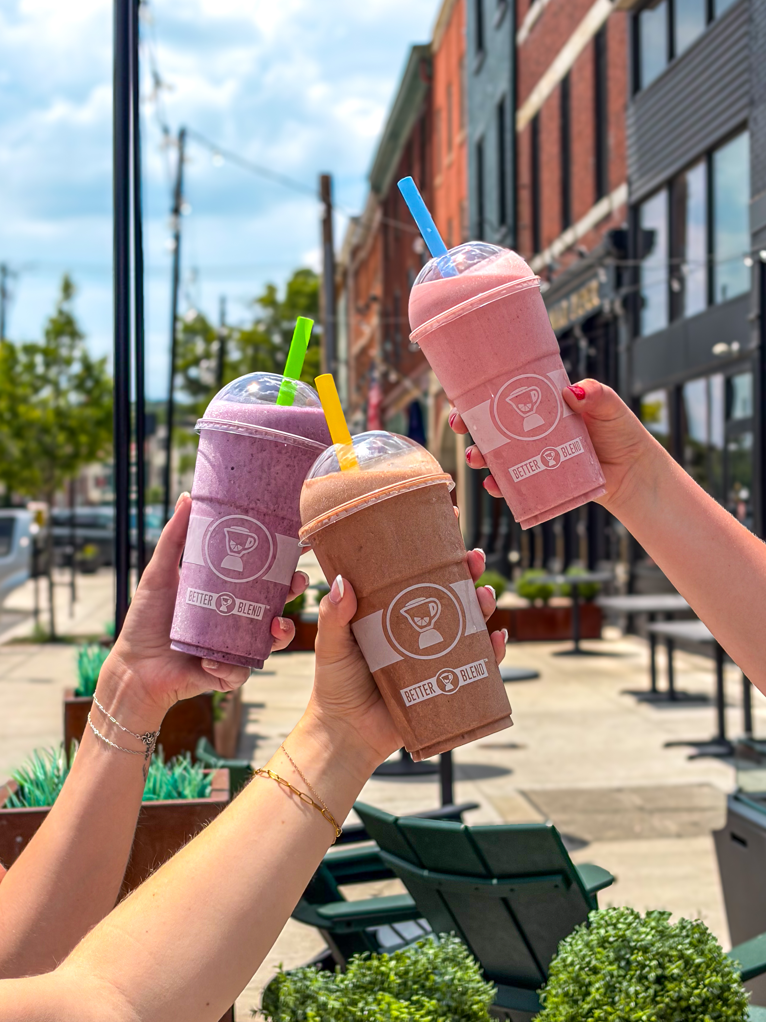 Three Better Blend smoothies held outdoors