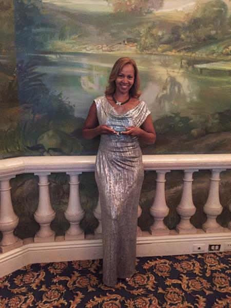 Selena Rogers, Senior Director of Corporate Accounts at Furnished Quarters, holds her Revenue Management Executive of the Year award from HSMAI