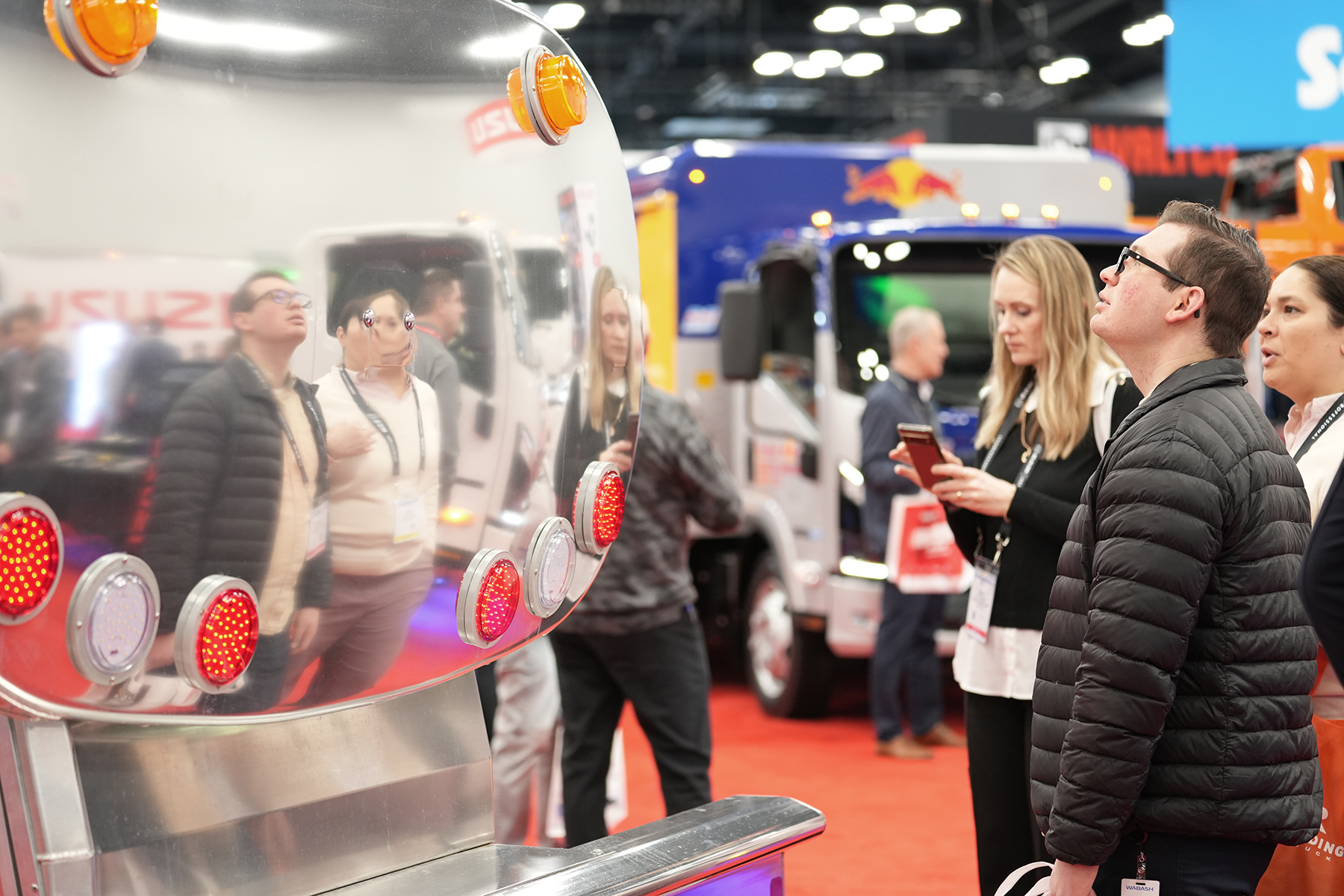 Work Truck Week attendees look at a tanker truck equipped with LED lights.