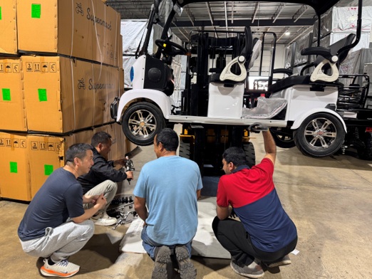 Company team leaders training distributors’ engineers on the vehicle chassis structure.