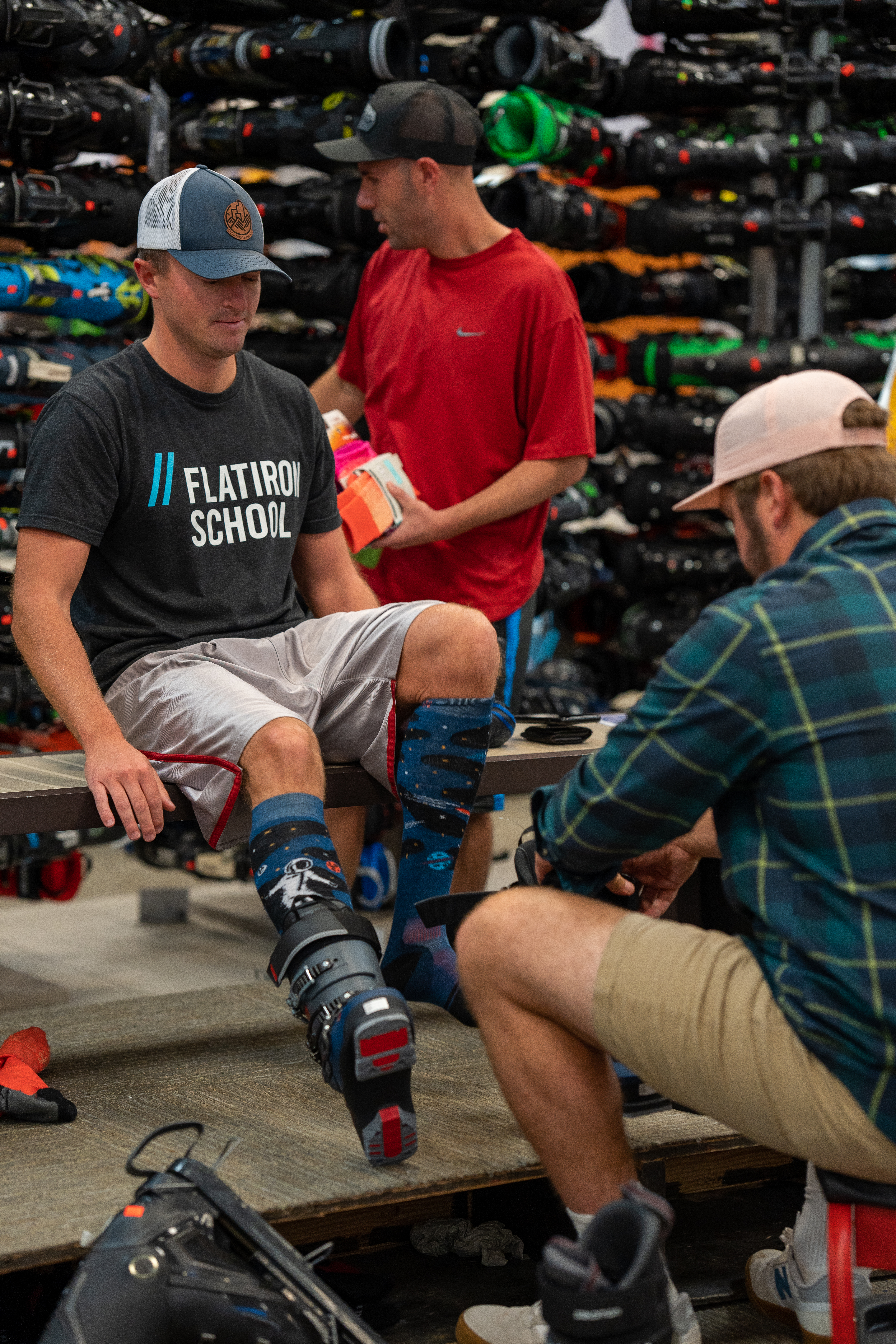 Christy Sports expert fitting a ski boot on a guest inside the store. 