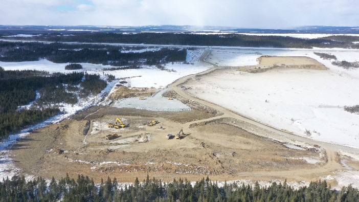 Overburden removal at the future process plant location looking NW with haul road in background.