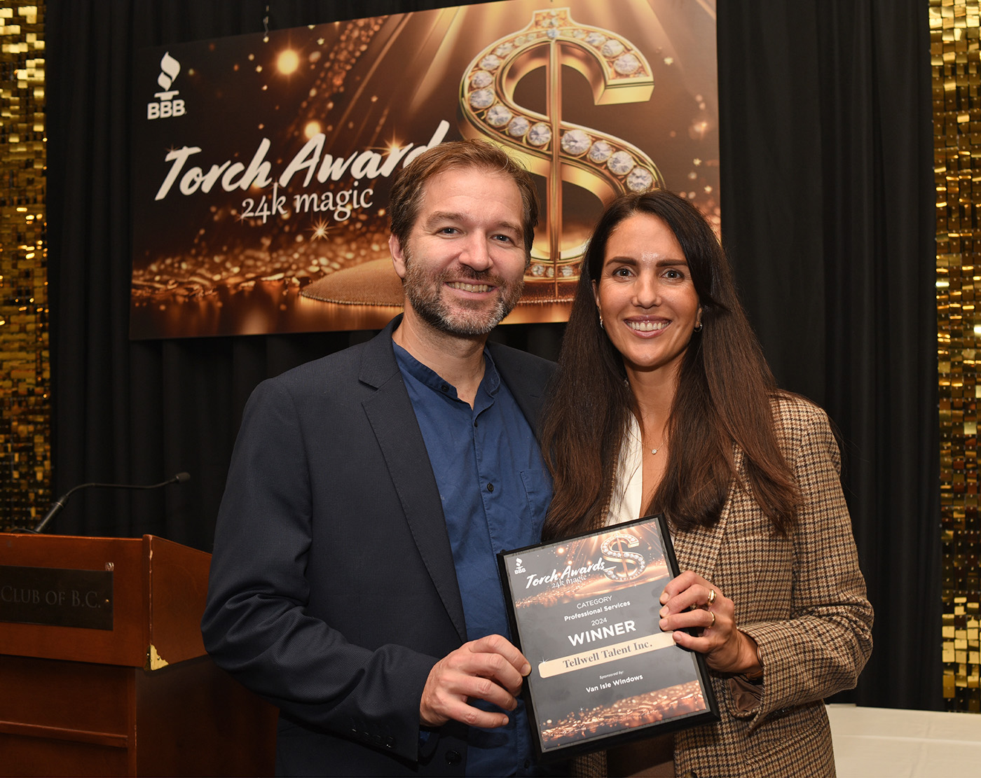 Tellwell Publishing Founder and CEO Timothy Lindsay and Head of Marketing Monica Martinez accepting the 2024 BBB Torch Award in the professional services category.